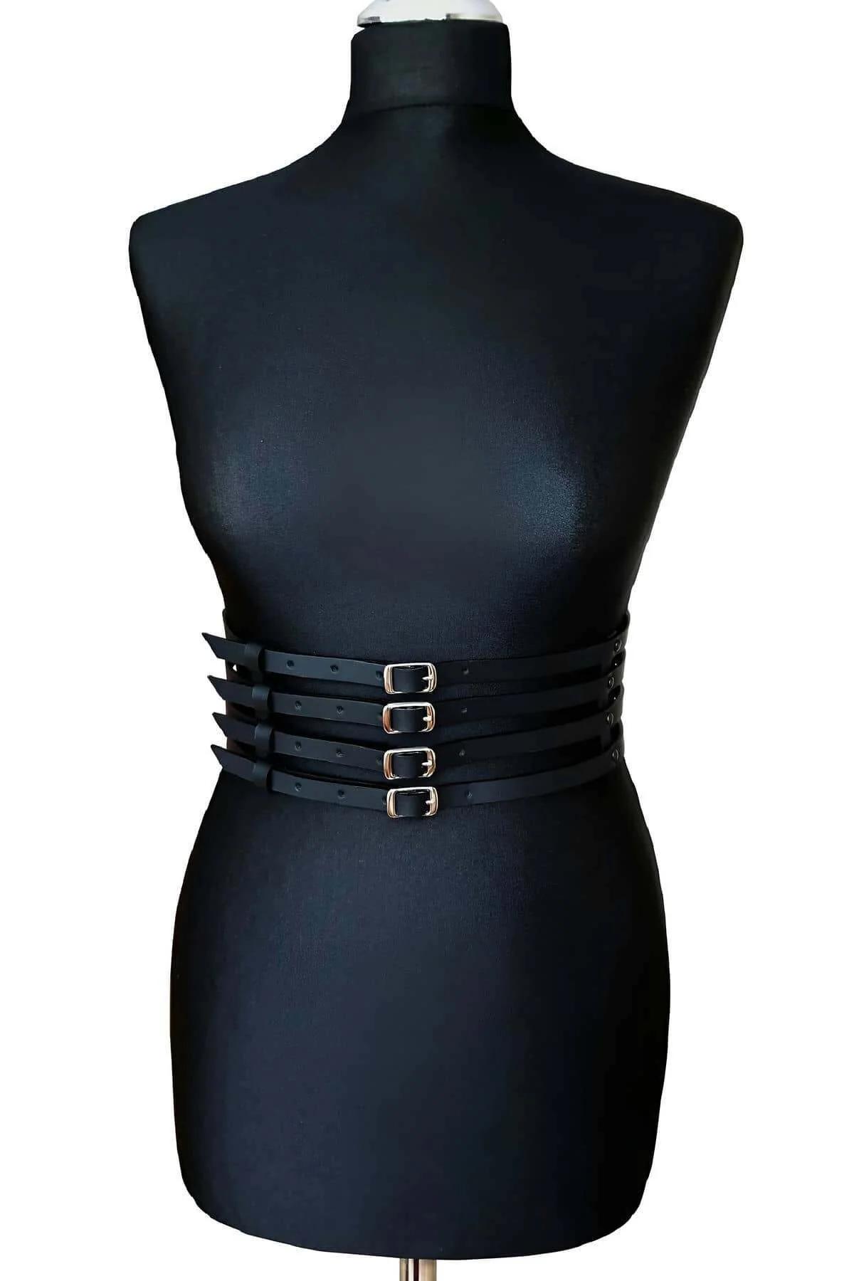 detail shot of four parallel black leather straps with even spacing on waspie belt