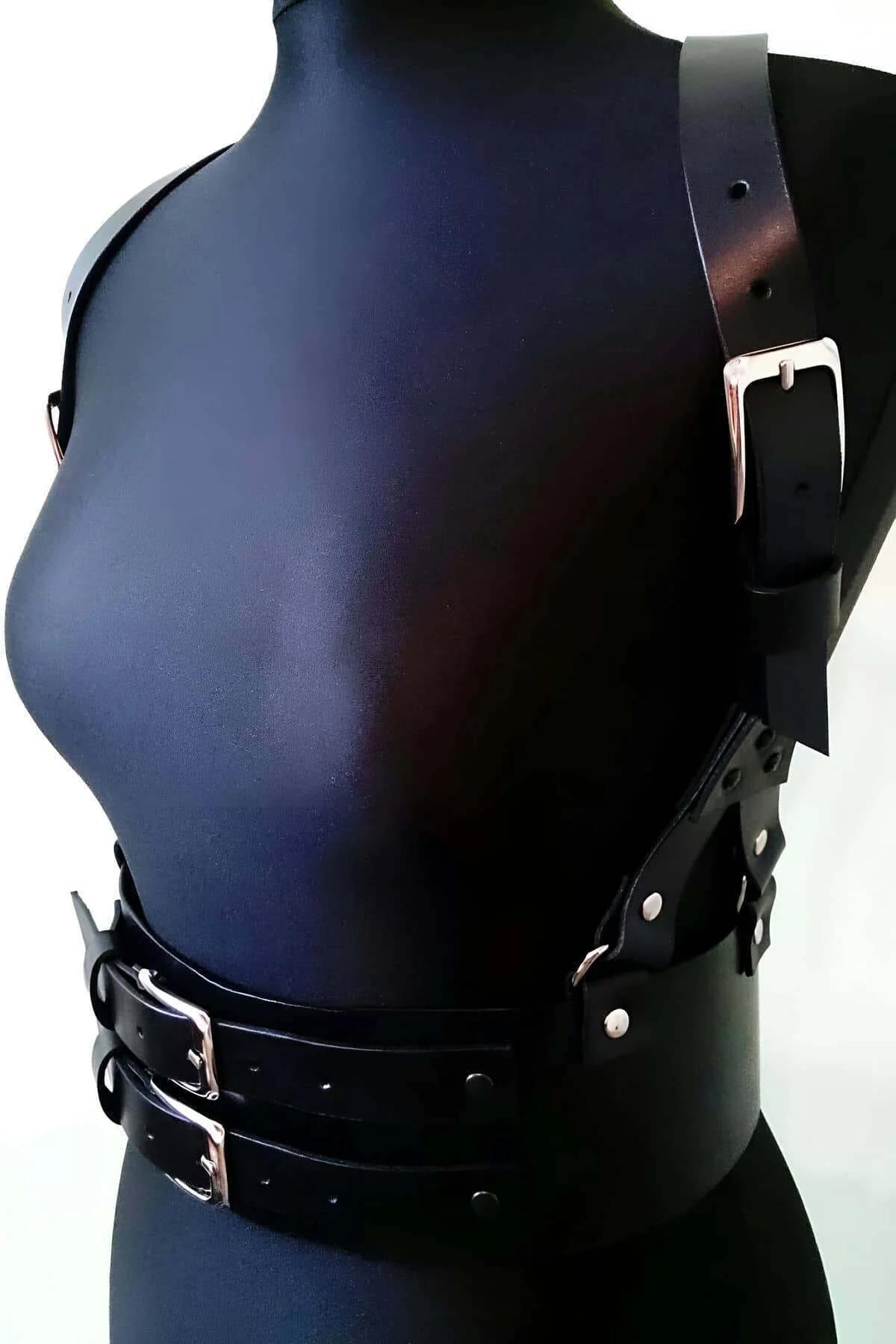 front view black faux leather body harness belt showing wide double-buckle waist band and chest strap detail