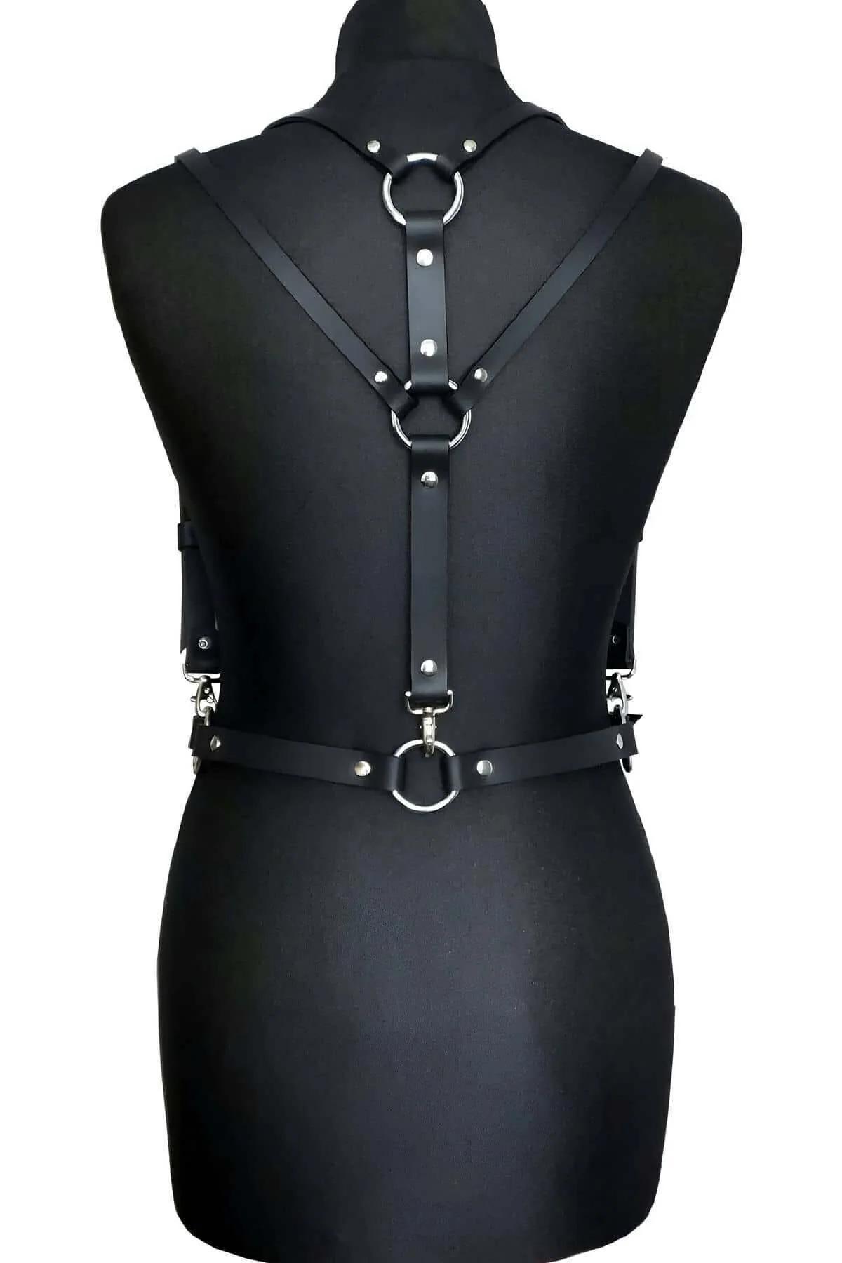 Black chest harness waist belt with silver rectangular buckle and strap keeper loop close-up