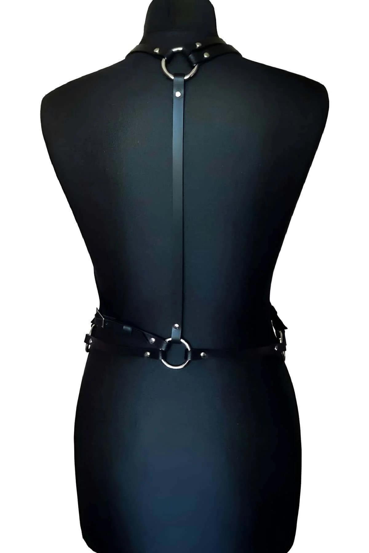 black chest harness side view showing D-ring junction and strap adjustment points