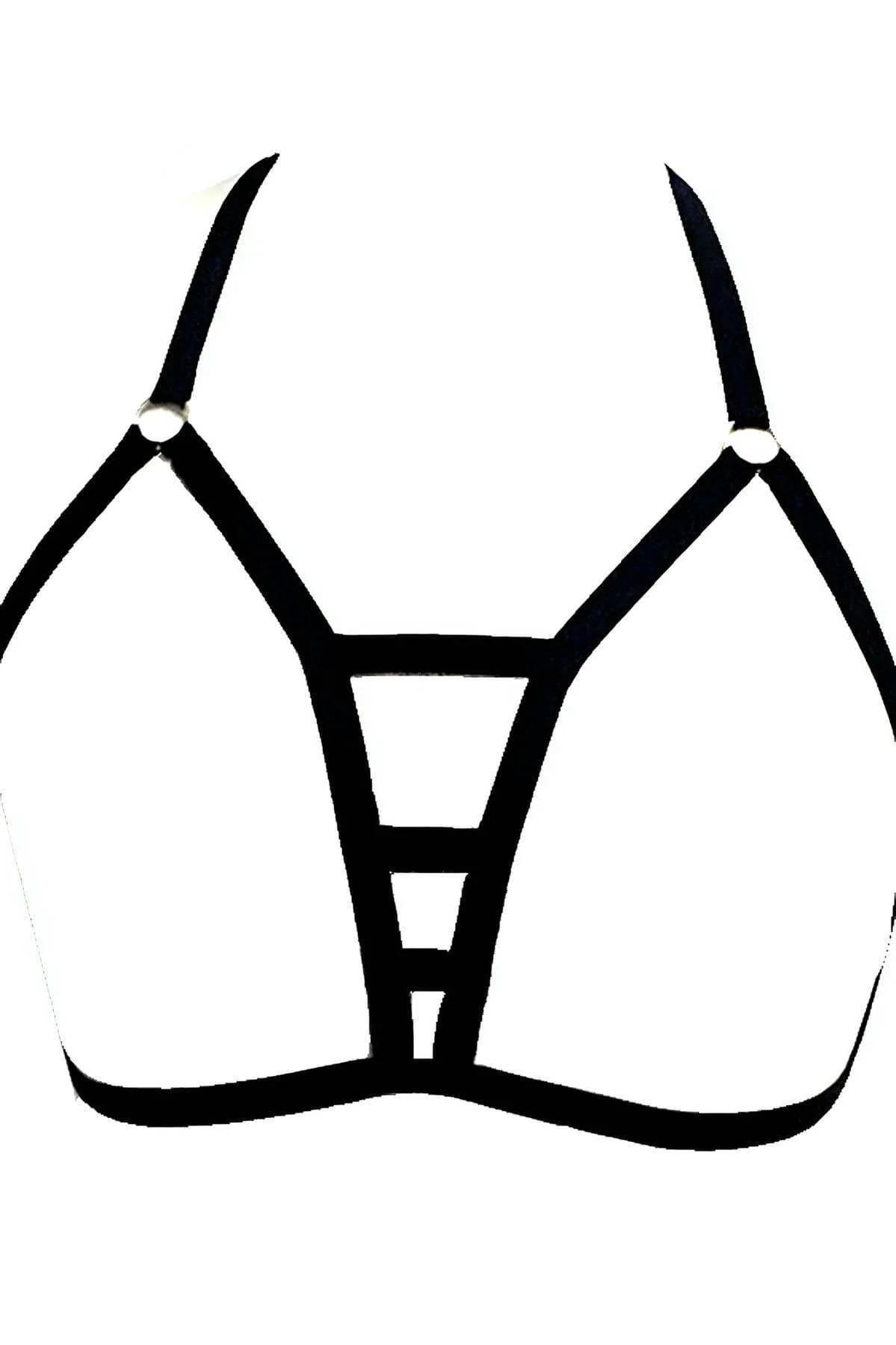 Close-up of gold-toned O-ring hardware on black nylon elastic shoulder strap of chest harness
