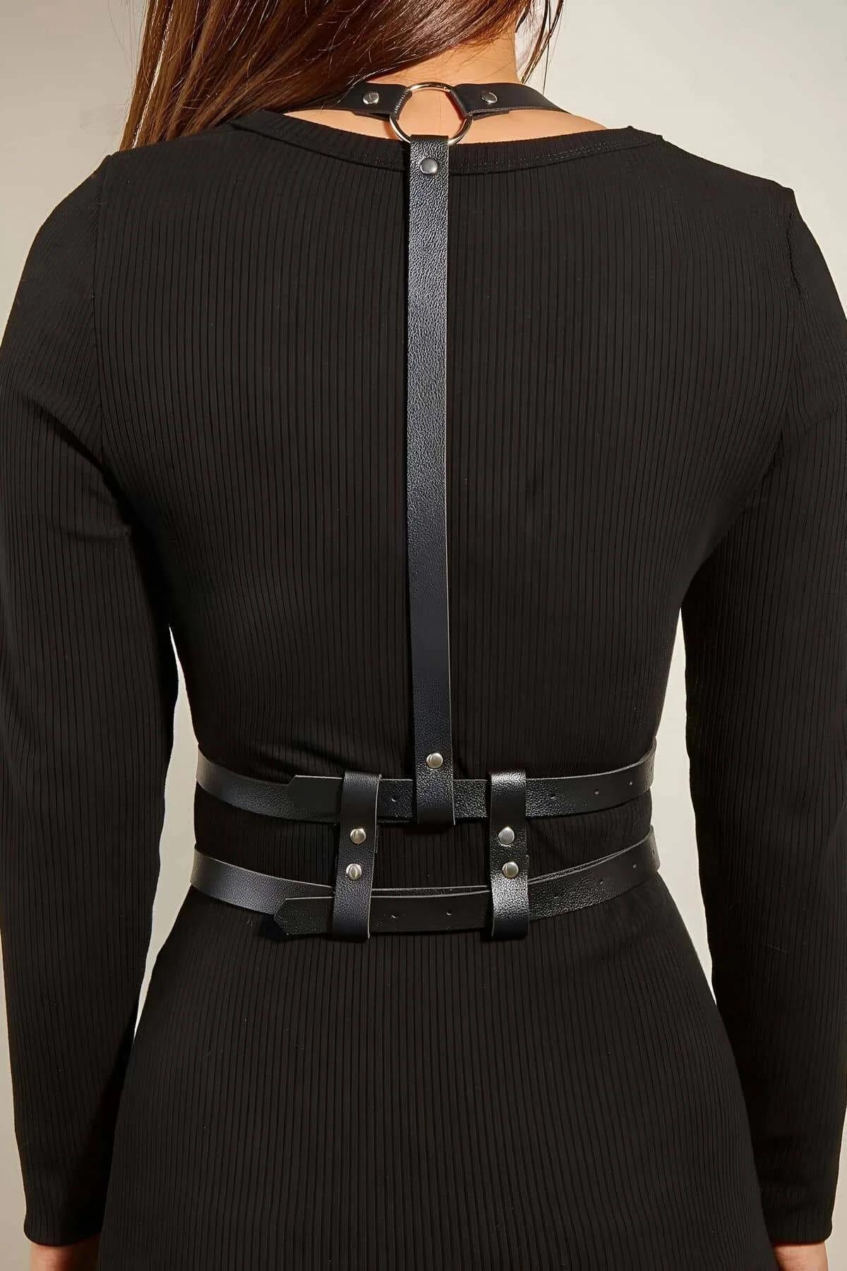 Close-up of silver rectangular buckles on black PU leather waist belts with visible punch holes