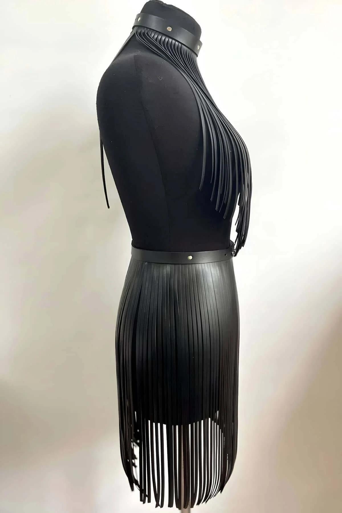 Close-up of black faux leather fringe strips on halter top with silver stud choker collar detail