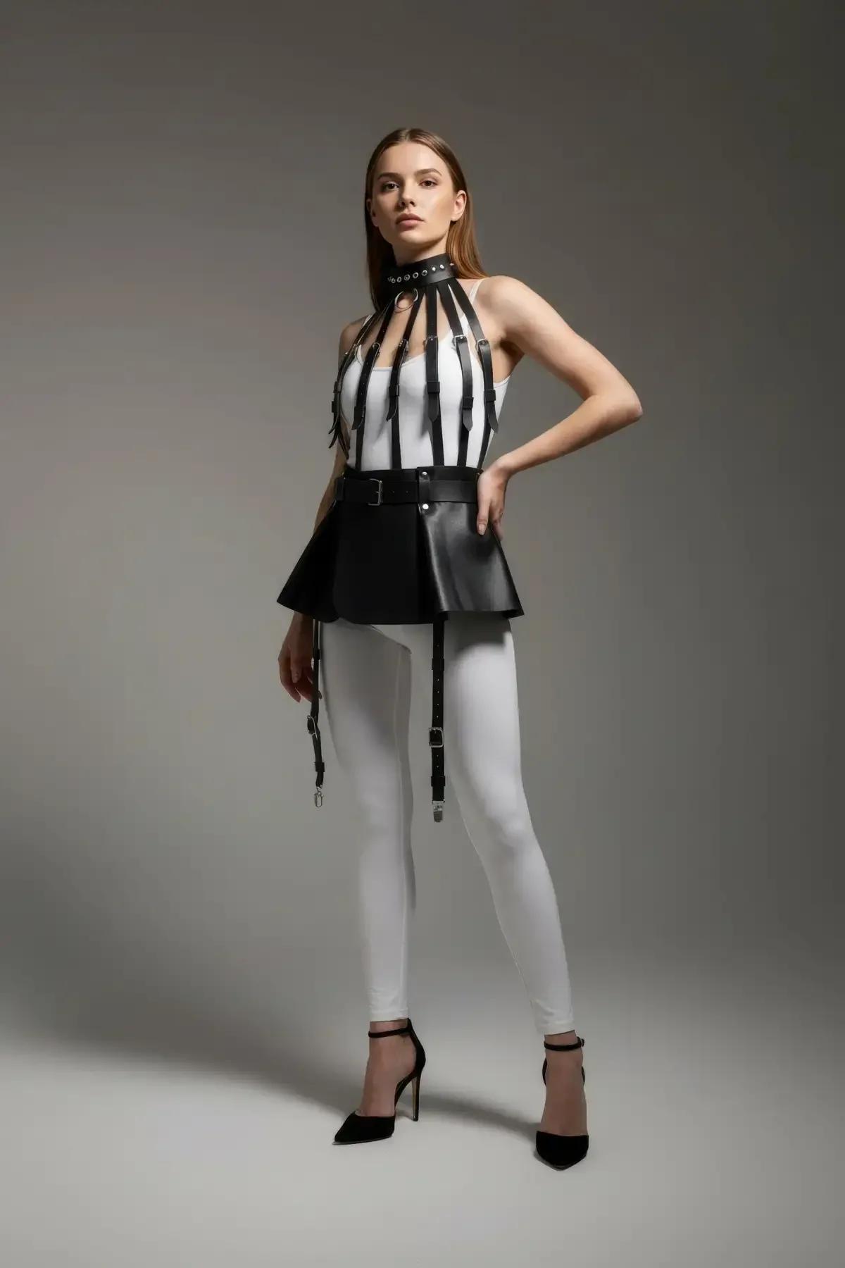 Black PU harness skirt with structured 6 cm waistband and dangling silver garter clips, front view