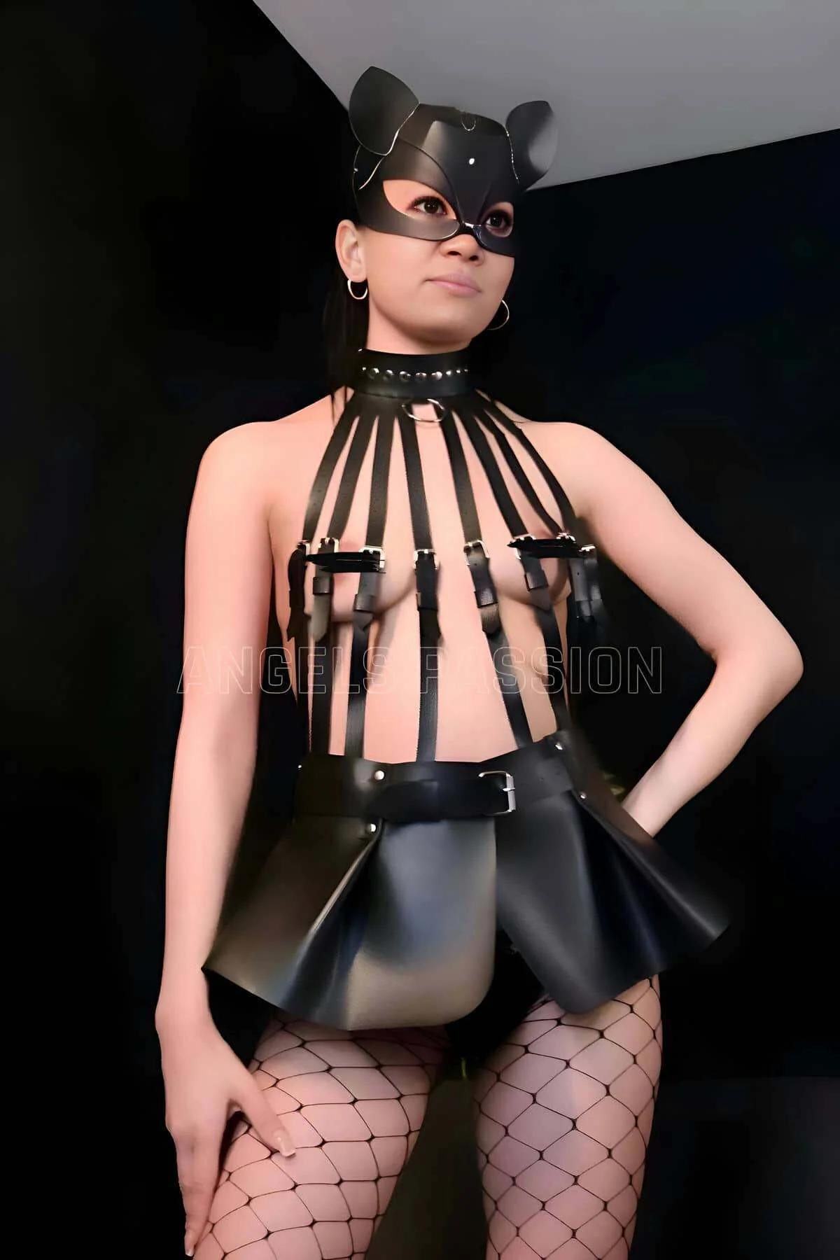 Black PU leather vertical strap bustier with studded choker collar and silver rectangular buckles, close-up detail