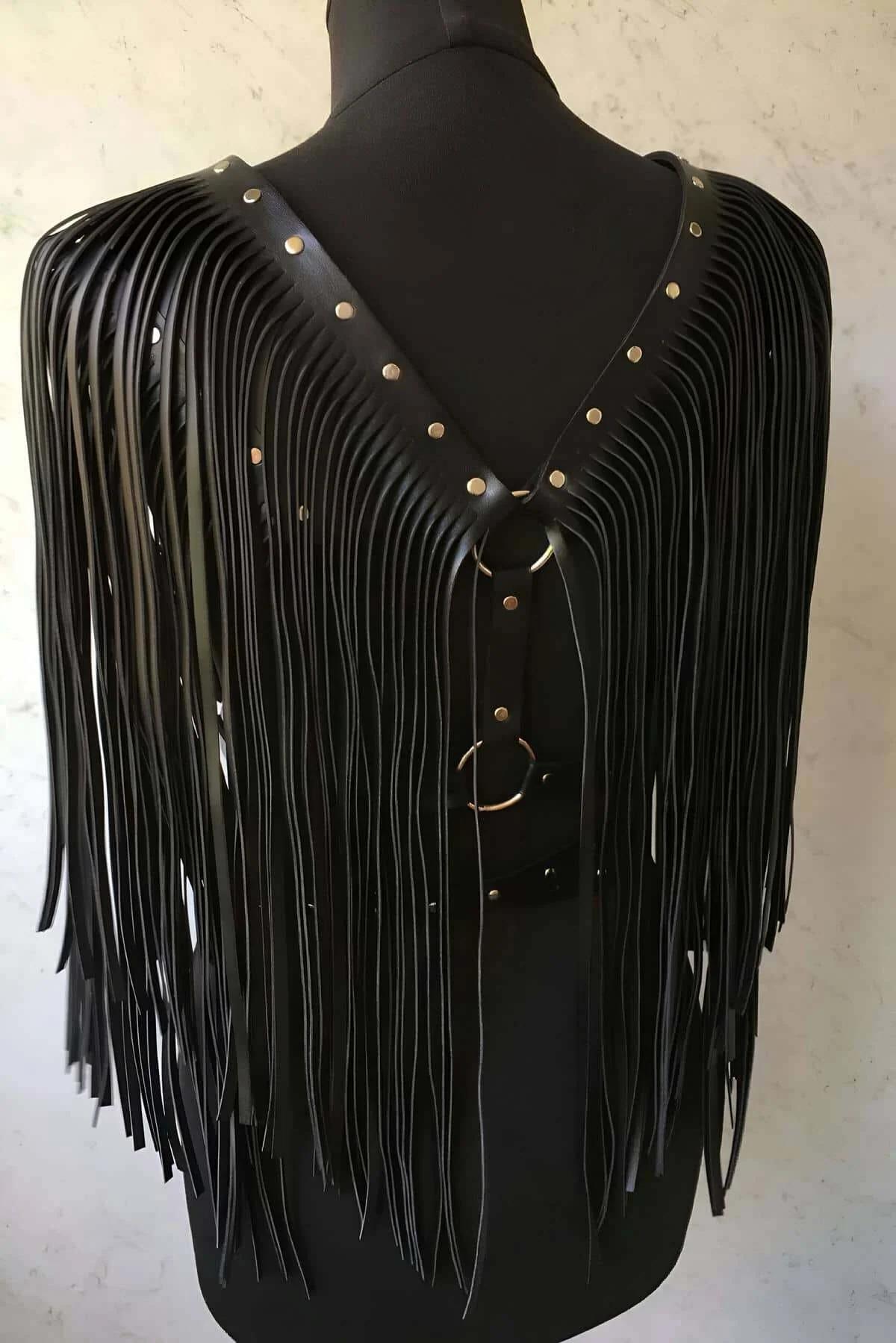 studded waist belt detail with gold-tone pin buckle on black faux leather harness