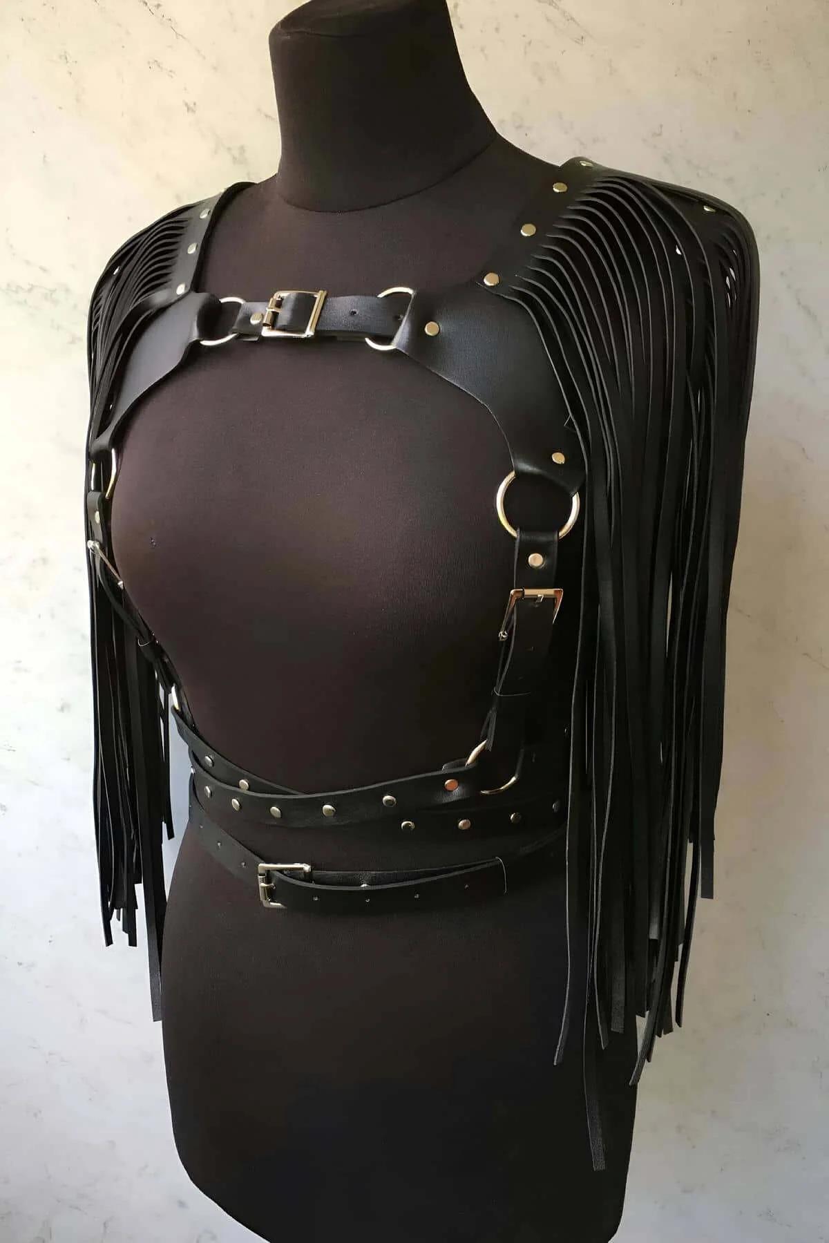 front view of black faux leather chest harness showing O-rings and adjustable side straps