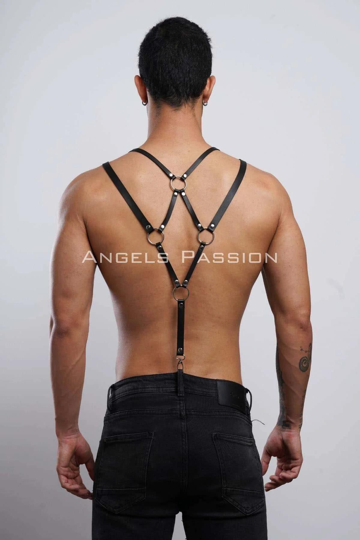 Black shoulder harness suspender straps clipping to waistband of black jeans