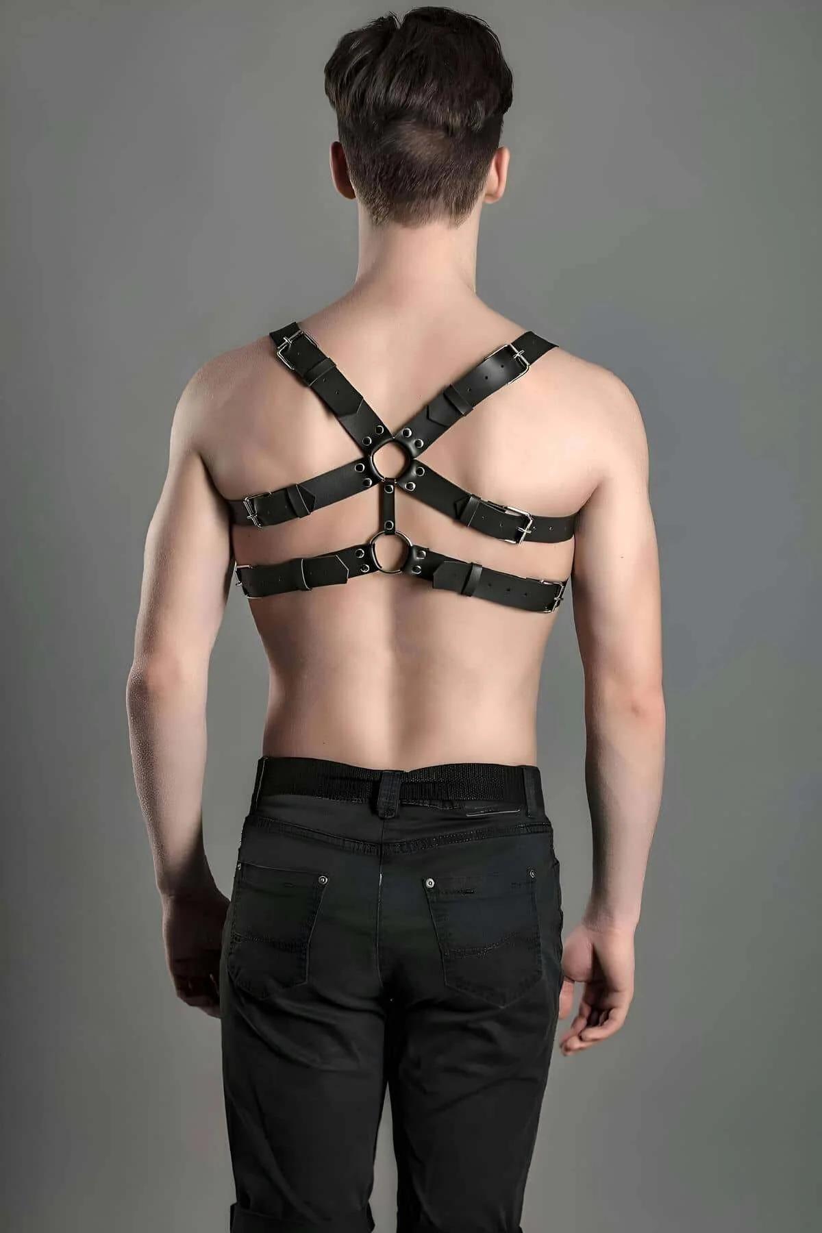 close-up of silver dome studs and grommets on black faux leather harness straps