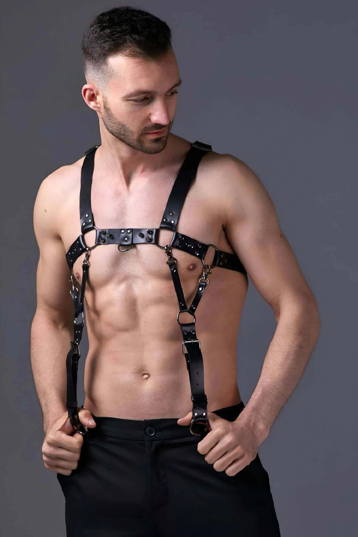 Side view of black PU leather harness showing diagonal shoulder-to-waist strap and buckle adjustment