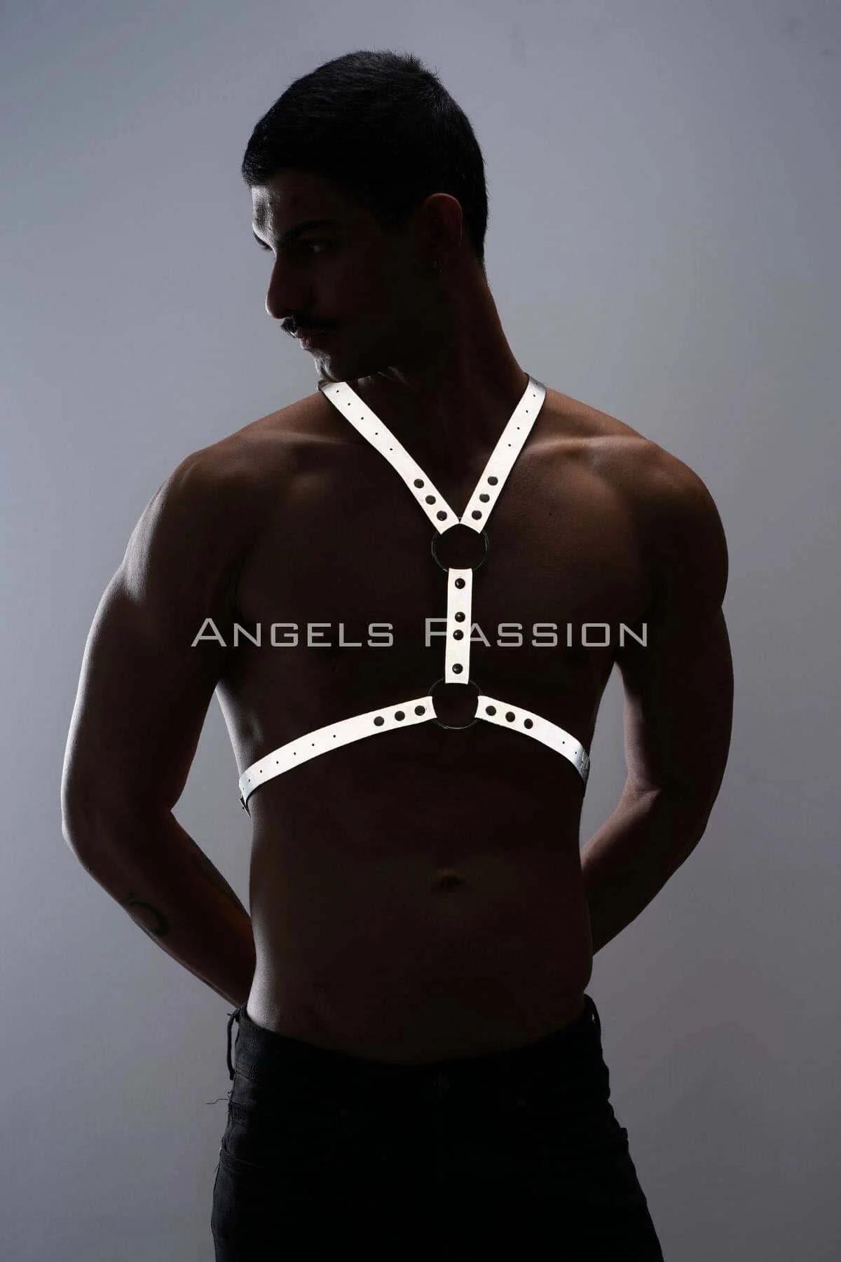 White reflective men's chest harness adjustable buckle detail against dark background