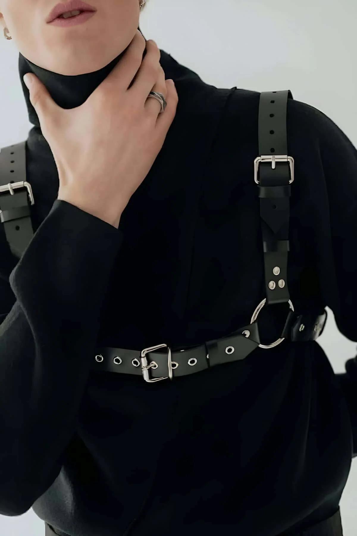 detachable silver curb-link chain hanging from harness central O-ring at chest level