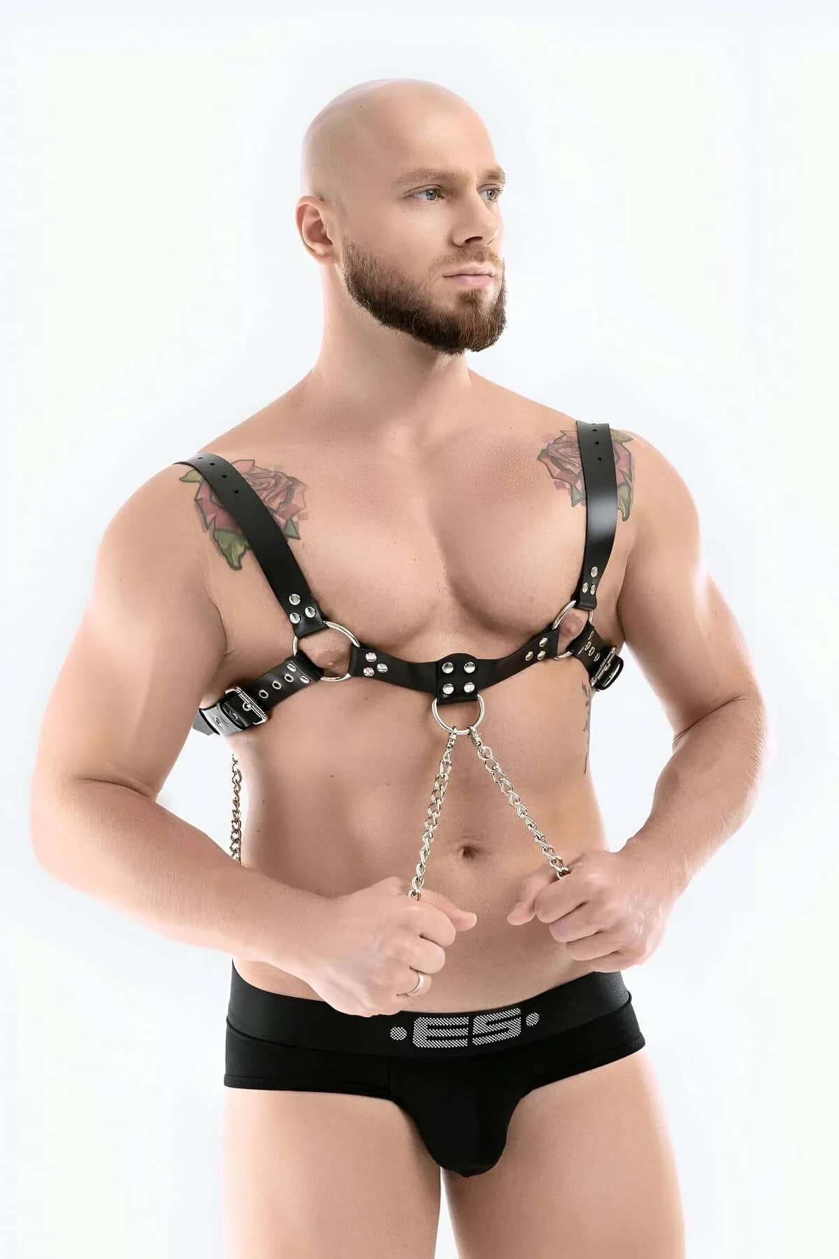 close-up of silver-tone O-ring and link chain detail on black PU leather chest harness