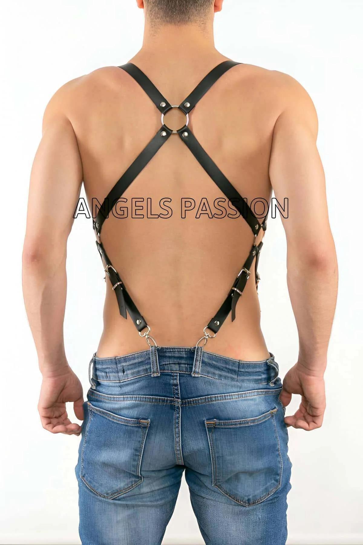 Close-up of silver O-ring junction and roller-buckle detail on black faux leather chest harness