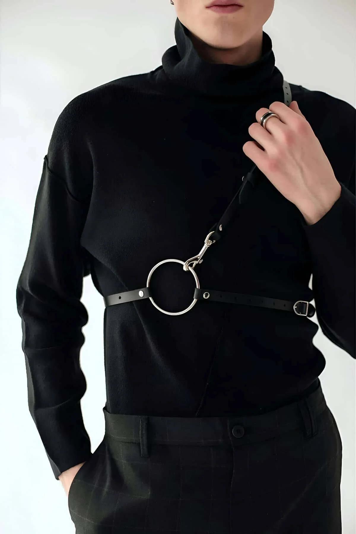 Black faux leather body harness showing D-ring side hardware and waist strap configuration