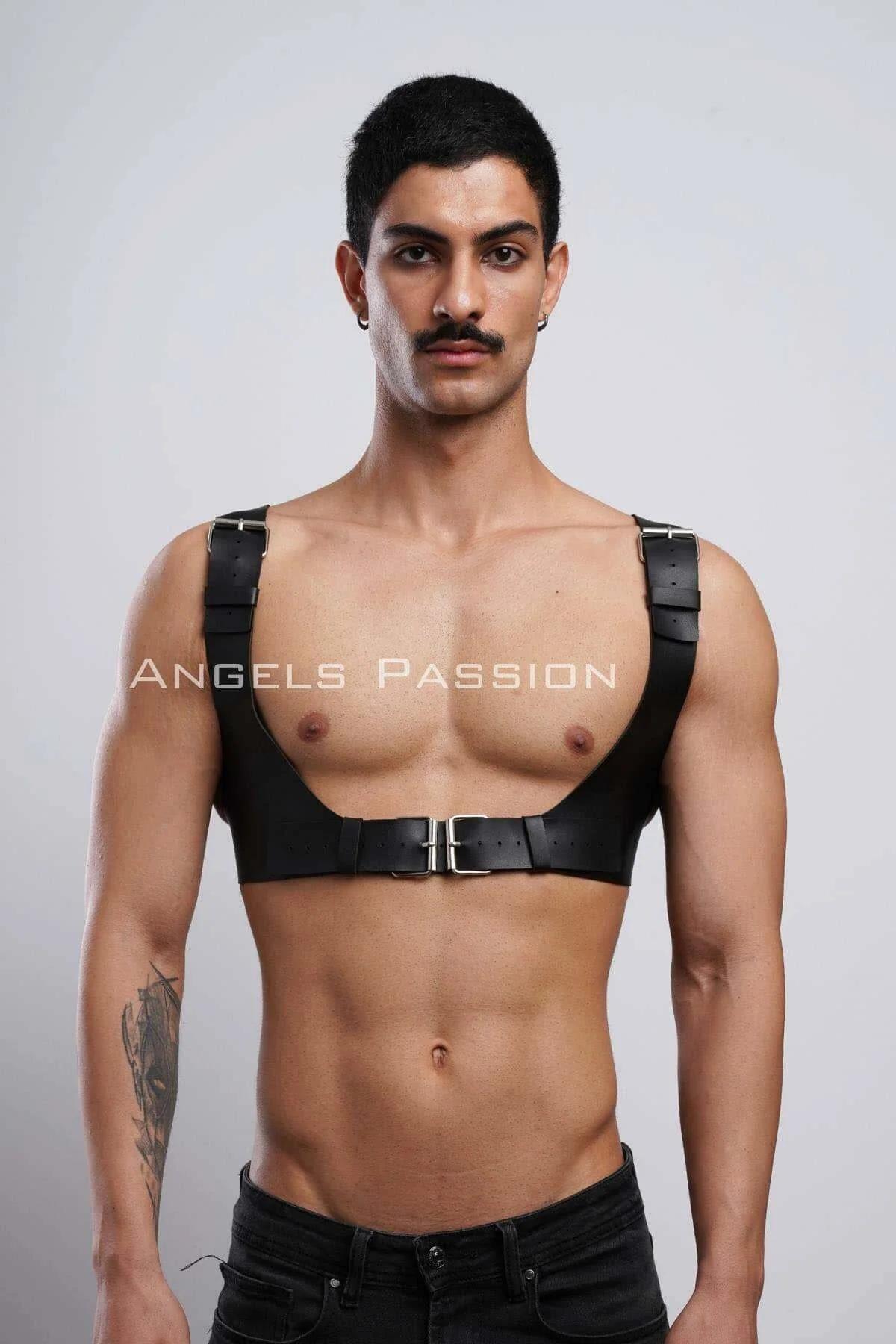Close-up of silver rectangular buckle on black faux leather chest harness center band