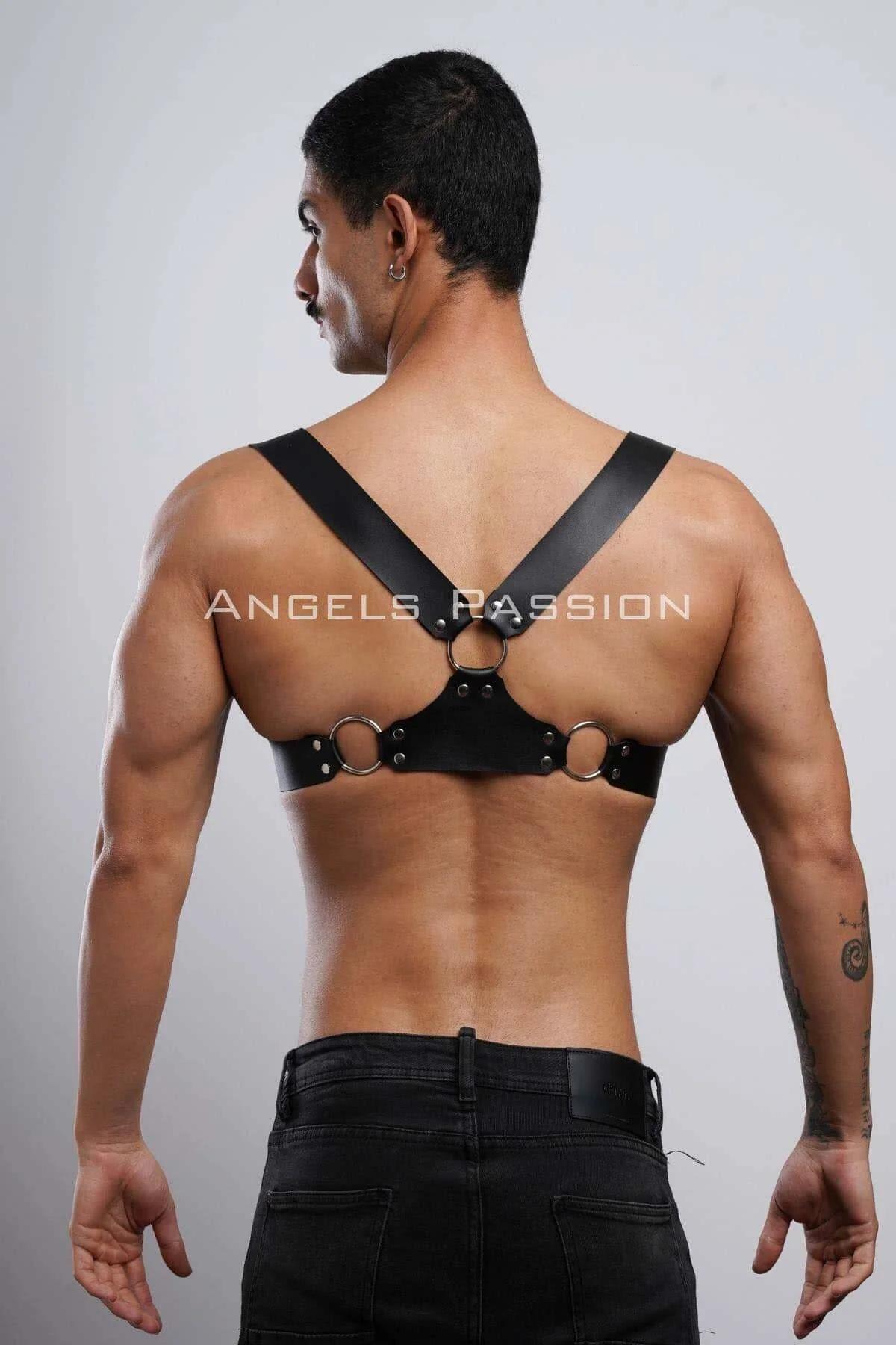 Flat lay of black faux leather adjustable chest harness showing buckle and strap construction detail