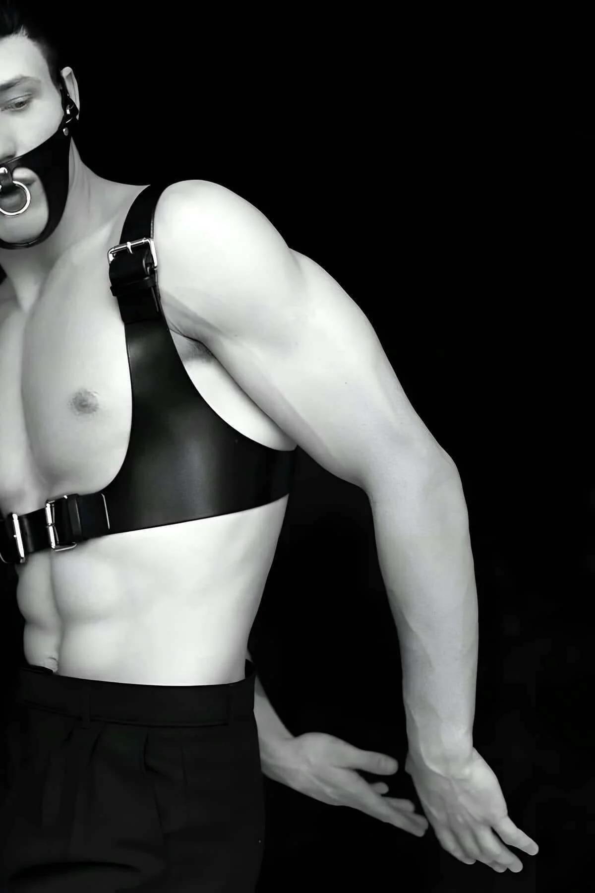 Front view of black PU chest harness showing dual silver pin buckles and wide front band