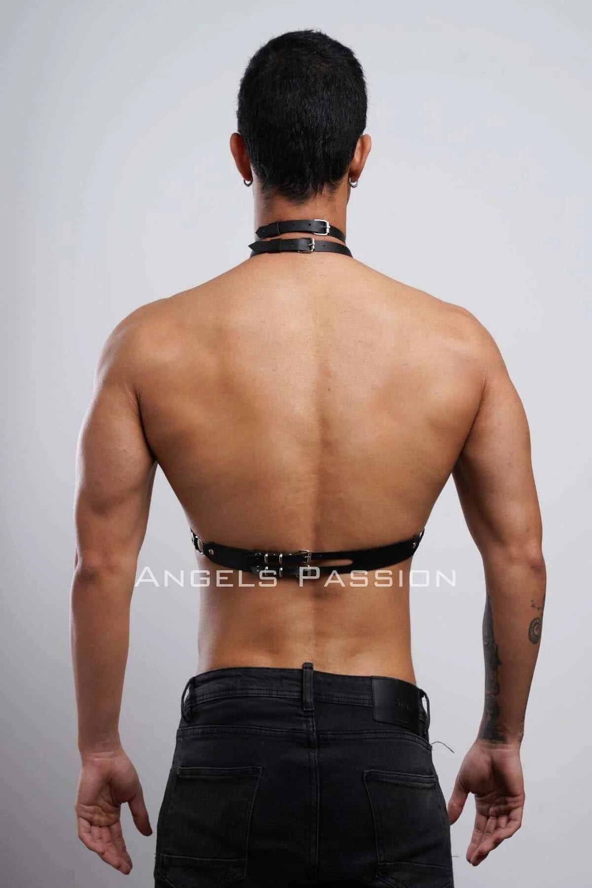 full torso view of black faux leather collar harness worn over bare skin with low-rise trousers