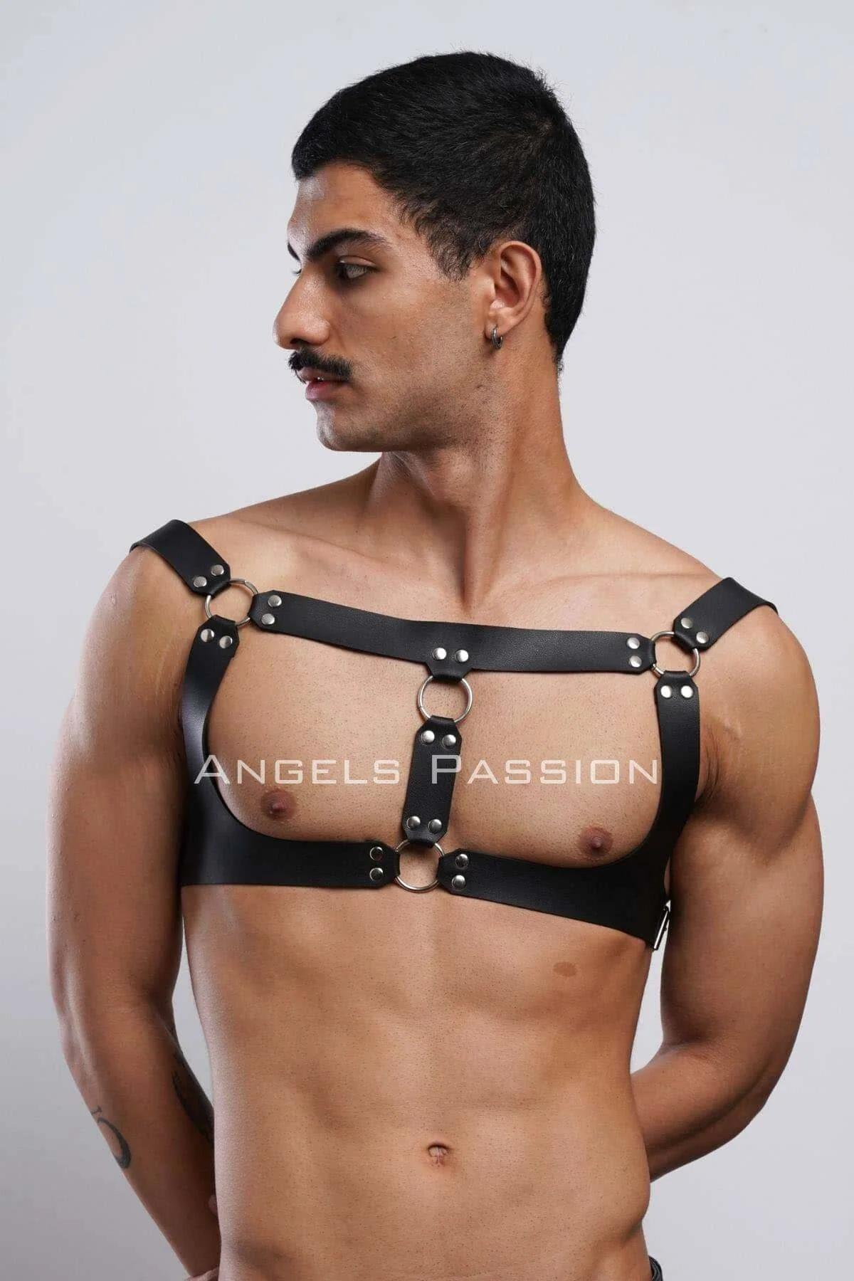 Black faux leather mens harness laid flat showing four adjustment buckles and full strap layout