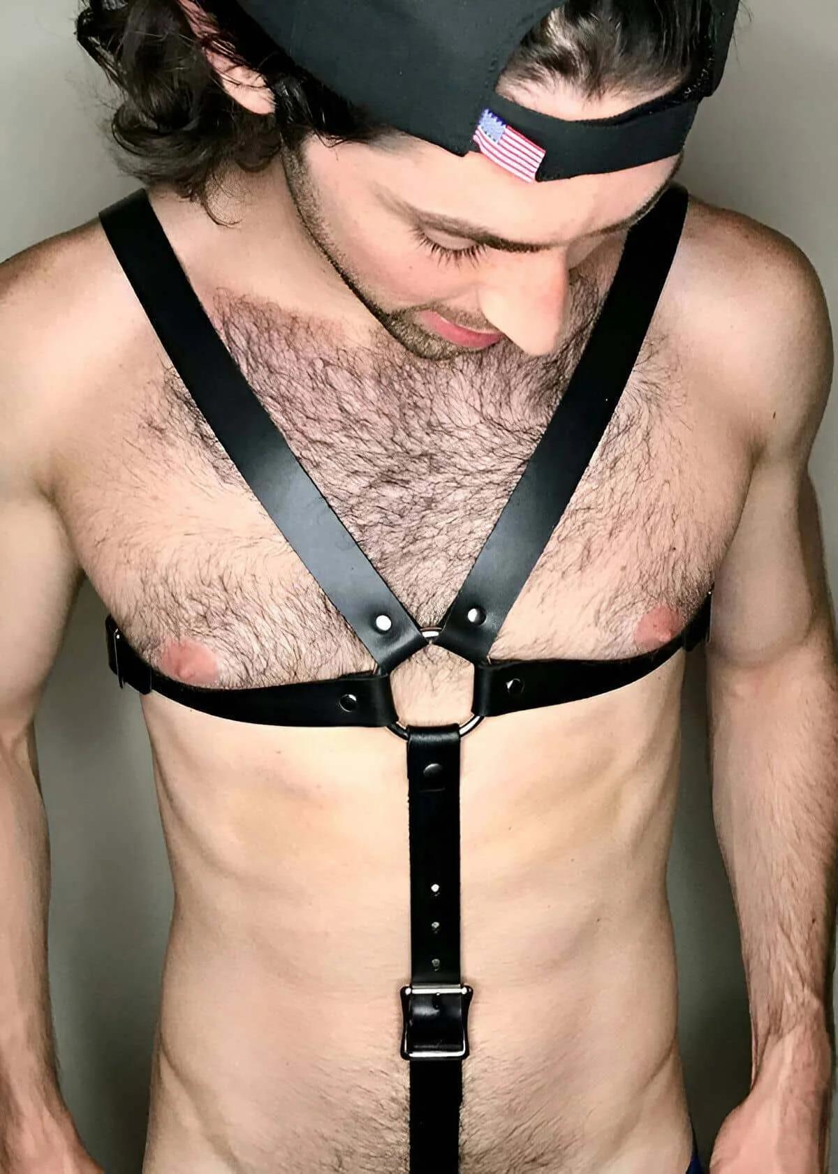 black faux leather chest harness with central O-ring silver buckle adjustable abdominal strap mens fashion accessory