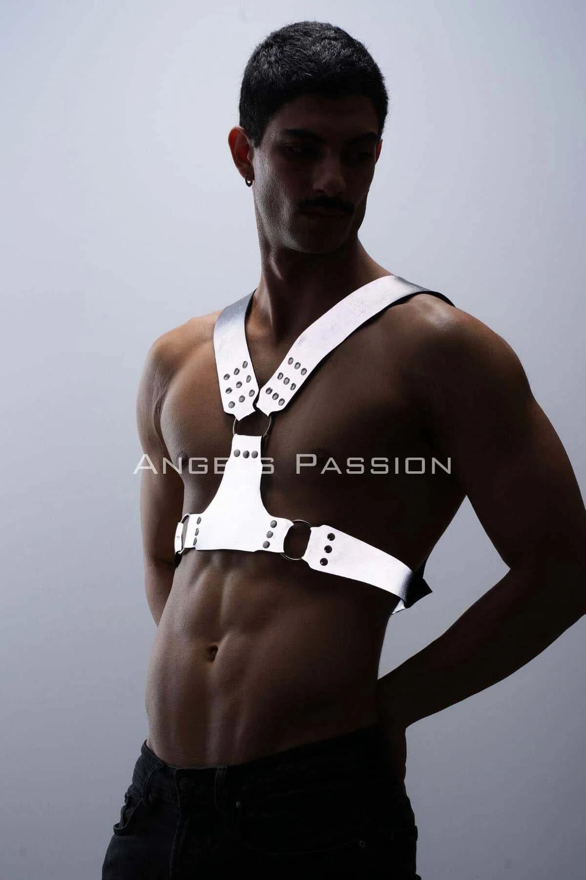 Detail shot of dark O-ring hardware against white reflective faux leather strap on mens festival harness
