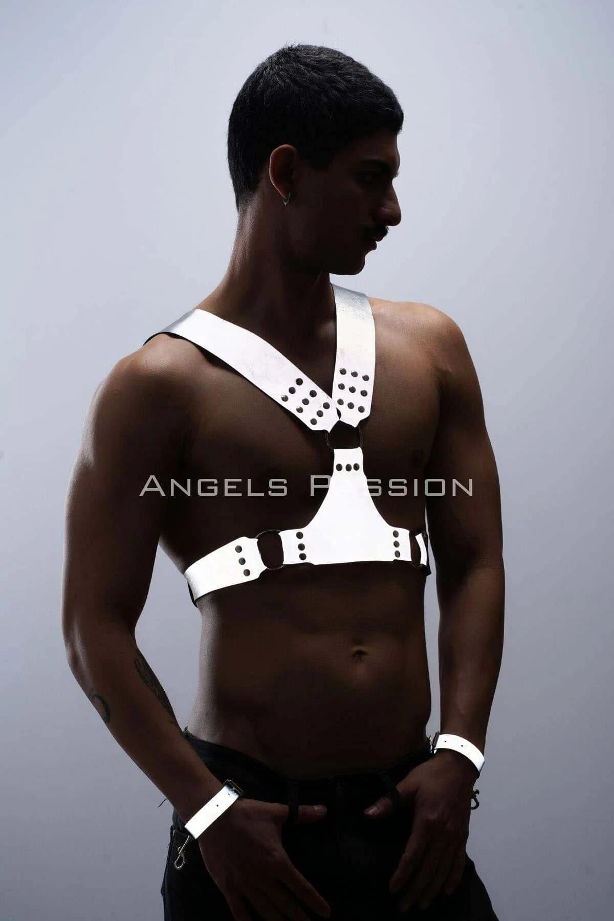 Front view of white reflective chest harness showing Y-strap layout and central silver O-ring with black dome studs