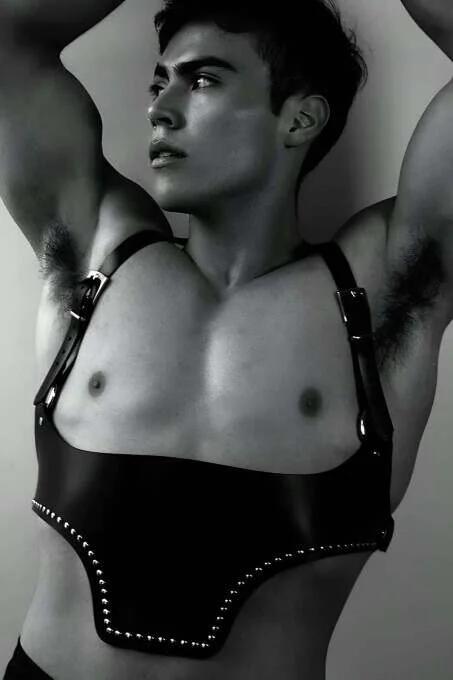 Close-up of silver stud trim row along black faux leather underbust harness hem edge