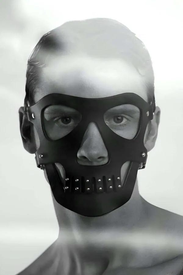 black faux leather skull mask with silver dome studs on jaw panel and open eye socket cutouts shown on mannequin