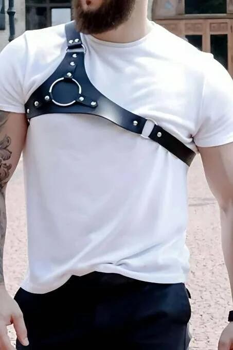 Close-up of silver O-ring and dome studs on black vegan leather shoulder harness strap