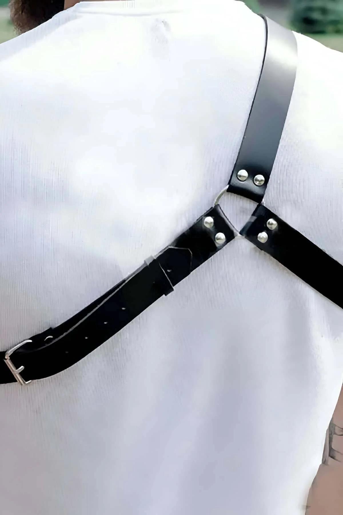 Black PU leather diagonal chest harness detail showing 3 cm strap width and stud trim