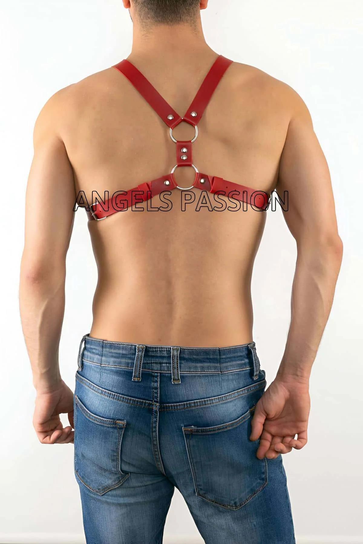 Close-up of silver O-ring junction on red faux leather chest harness with rivet detail