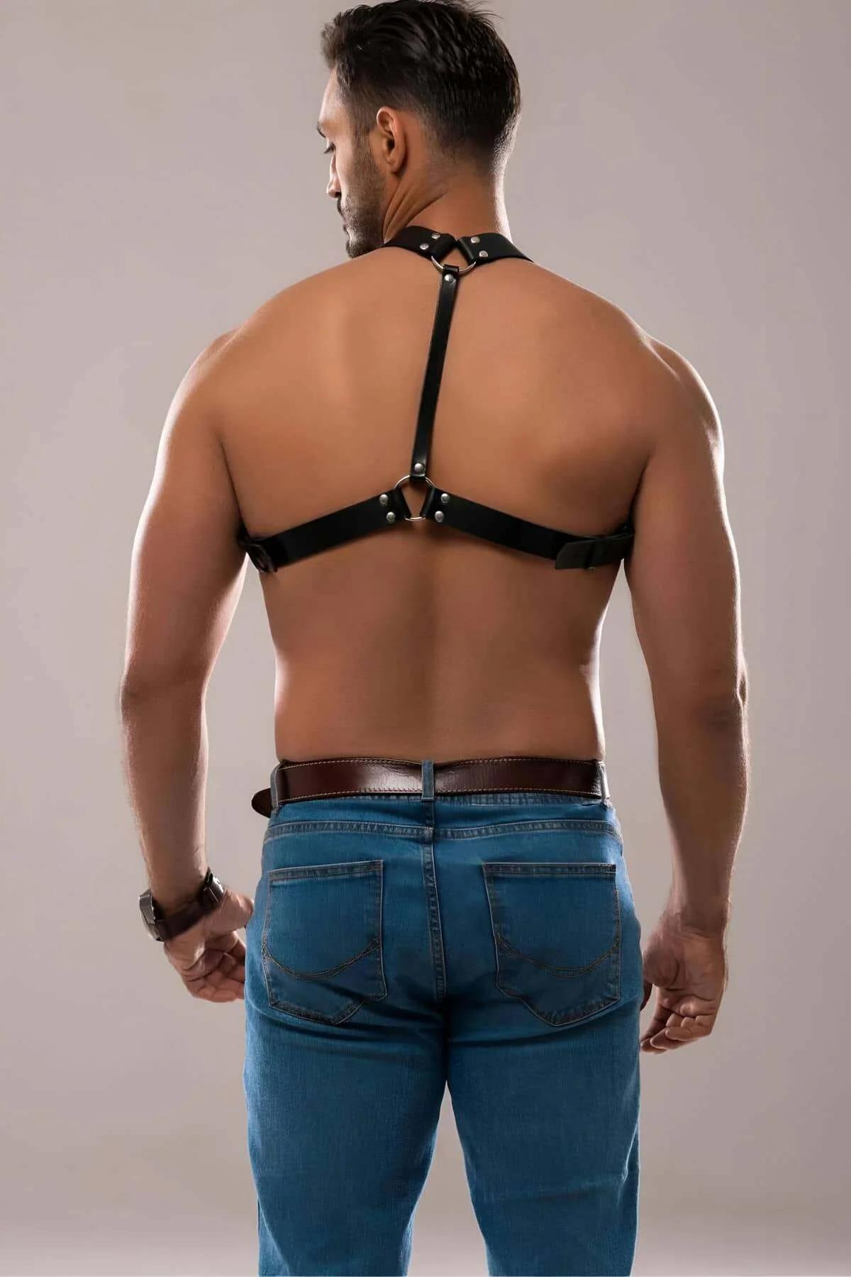 black faux leather mens chest harness flat lay showing full strap configuration and O-ring detail