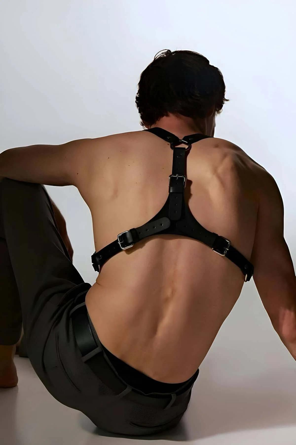 Front view black PU leather chest harness showing wide chest band and four silver buckles