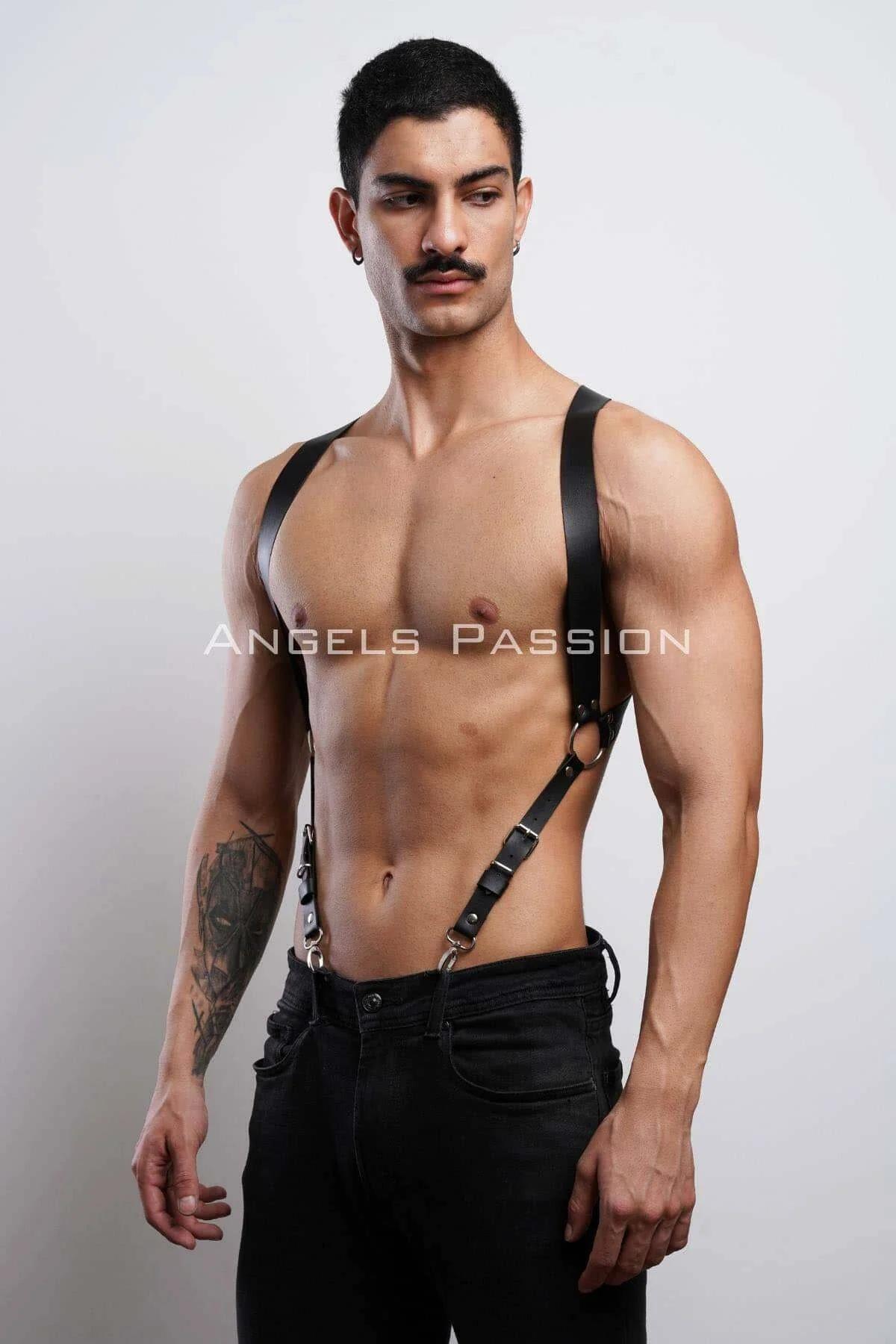Mens black faux leather shoulder harness layered over black jeans outfit styling