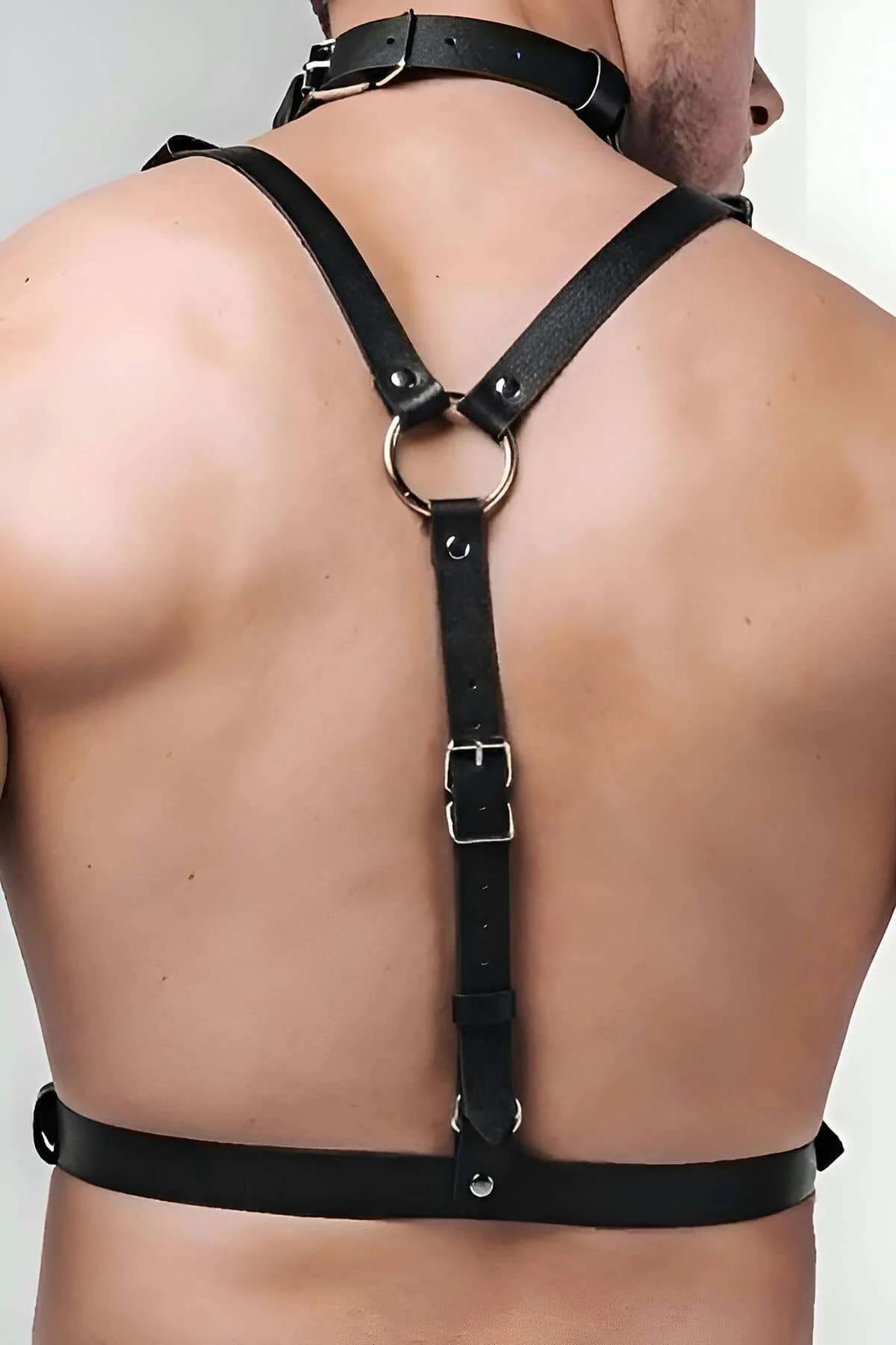 Close-up of silver rectangular buckle on black faux leather shoulder strap with multi-hole adjustment row