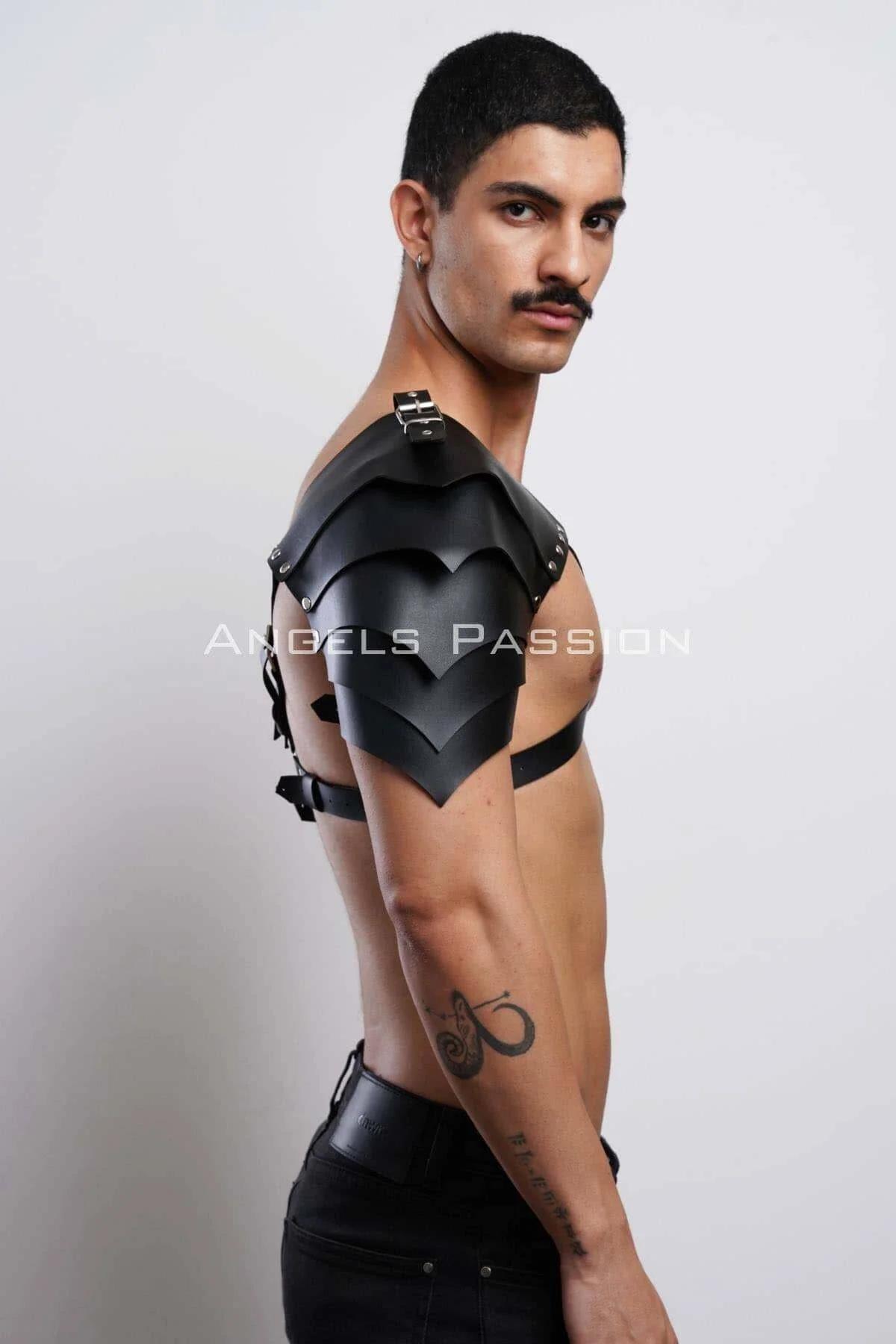 Detail shot of silver-tone O-ring and pin-buckle on black faux leather mens chest harness