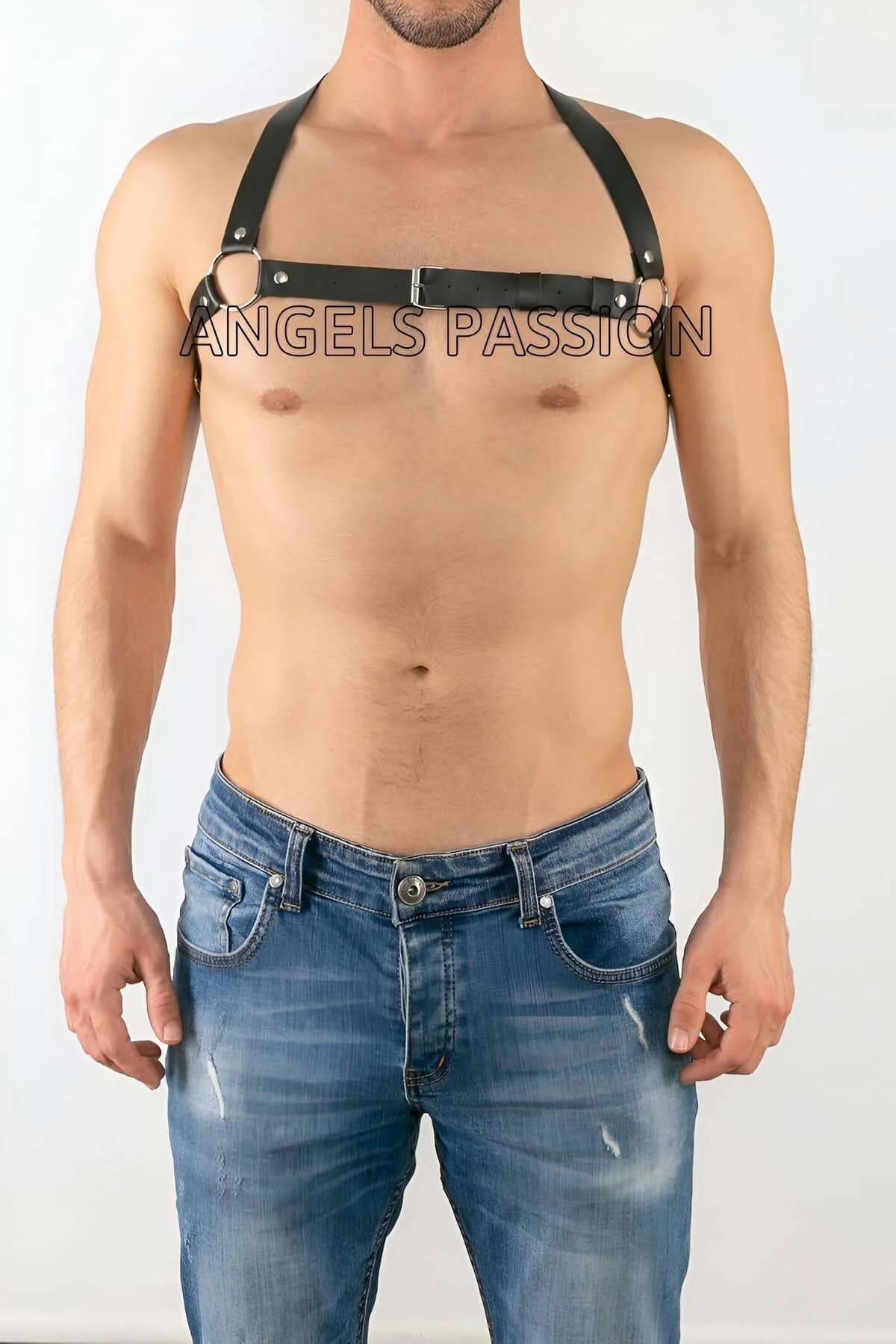 Black faux leather chest harness with central silver O-ring and rectangular buckle worn by male model over bare chest