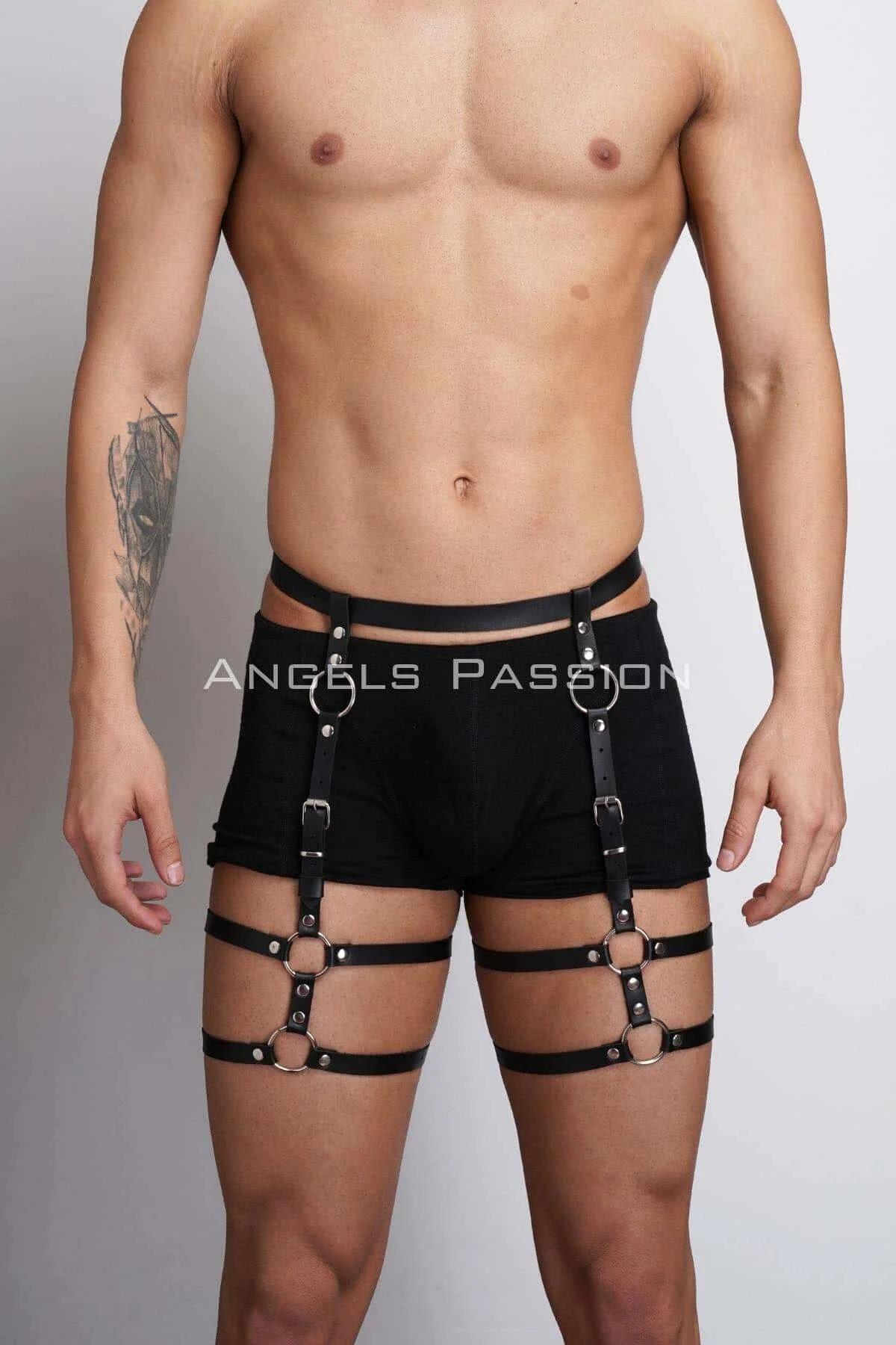 Close-up of silver O-rings and black faux leather straps on adjustable thigh harness
