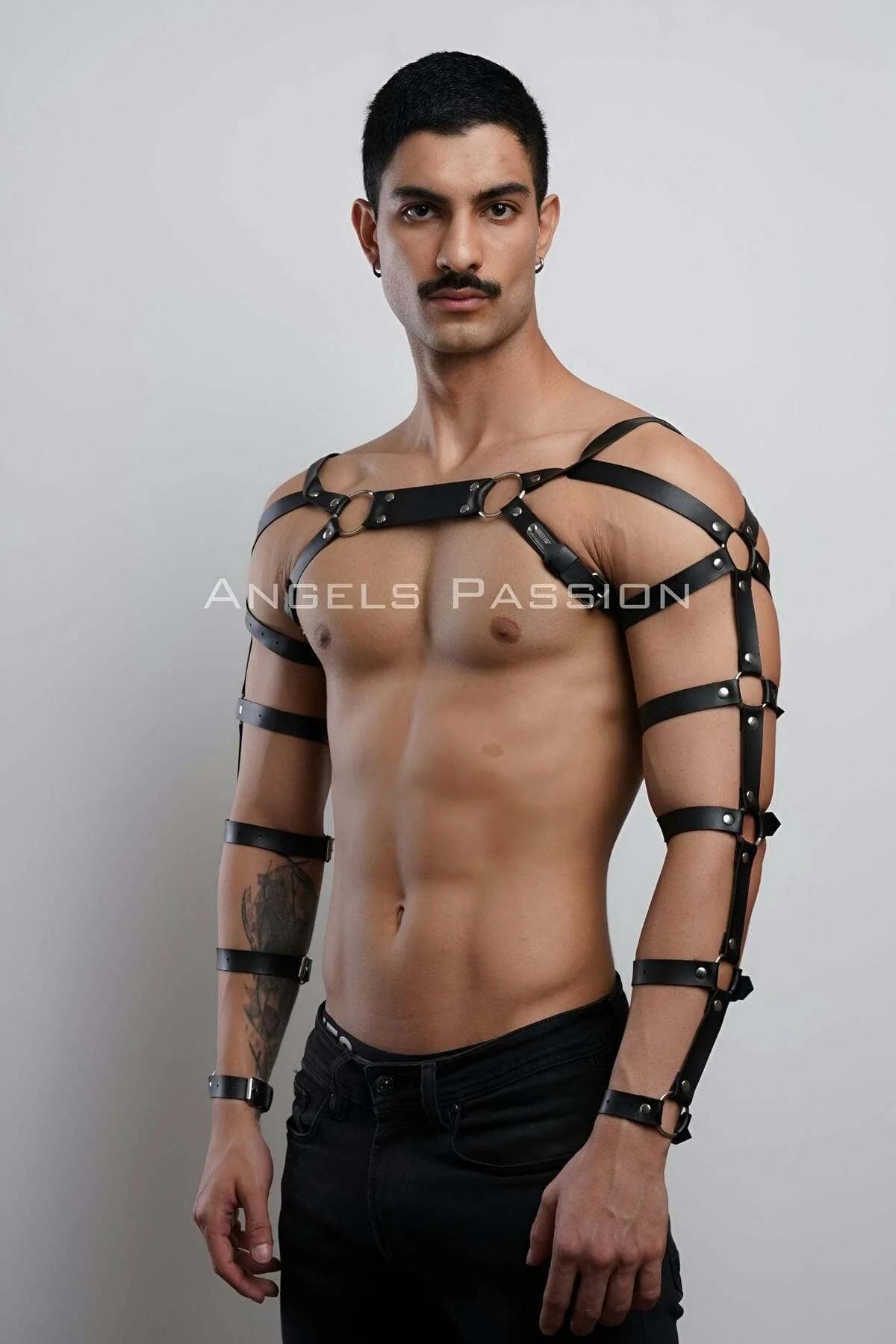 close-up of silver O-rings and rectangular bridge connector on black faux leather chest harness