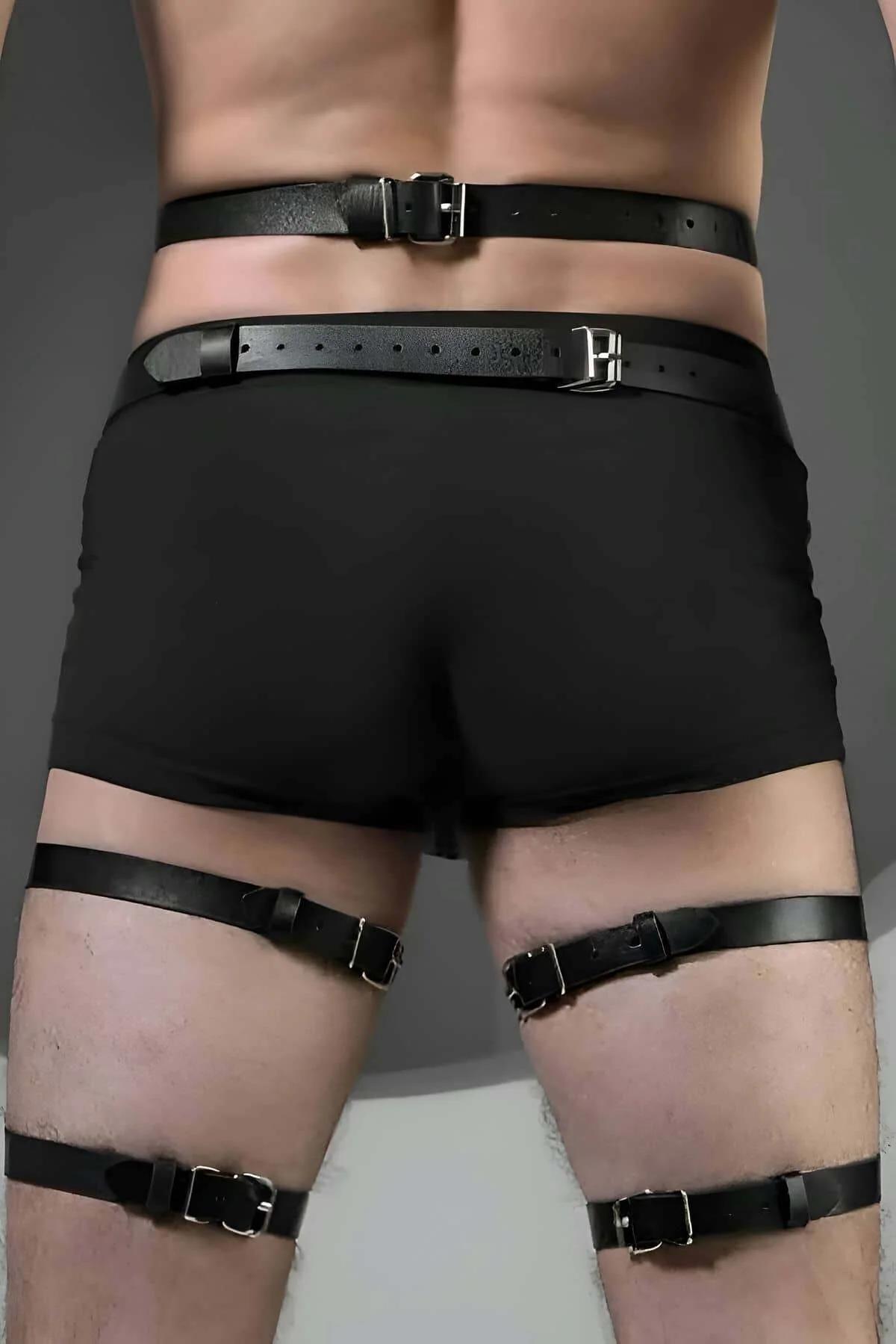 close-up of silver O-ring connection point on black faux leather thigh harness strap