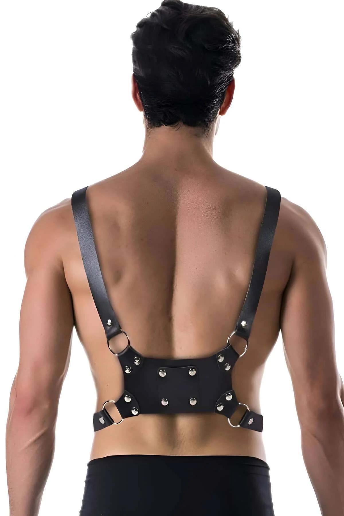 Close-up of silver O-ring rivet detail on black faux leather chest harness center strap