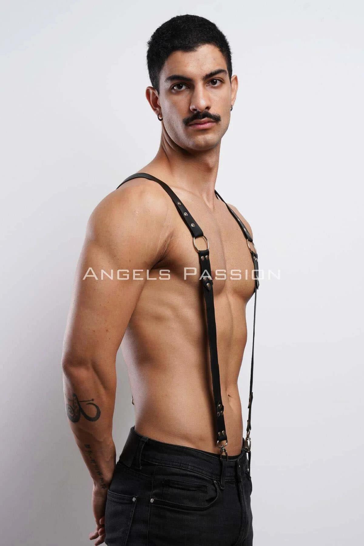 Close-up of gold O-ring and silver rivet detail on black faux leather shoulder harness straps