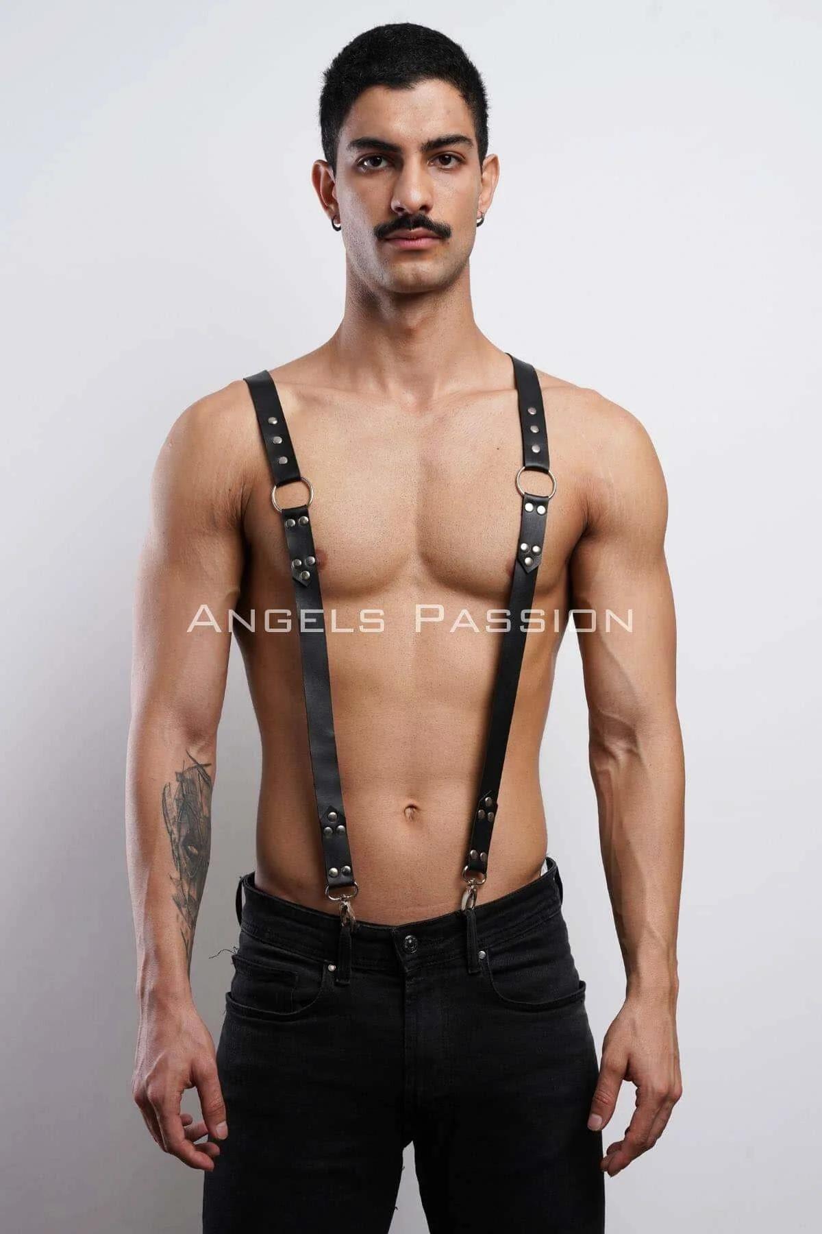 Black faux leather shoulder harness layered over white tee showing suspender silhouette