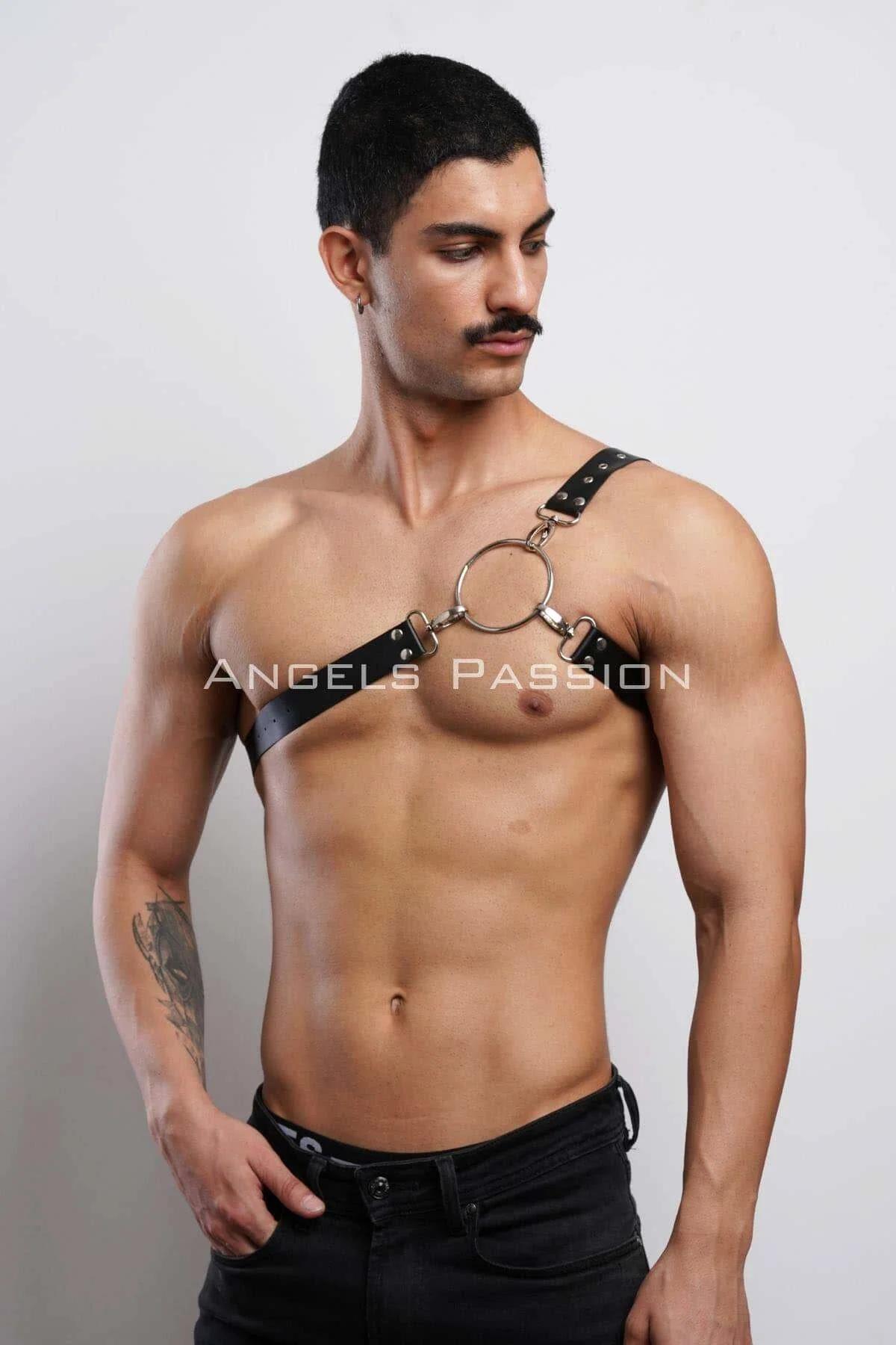 Close-up of gold-tone O-ring and D-ring connectors on black PU faux leather chest harness