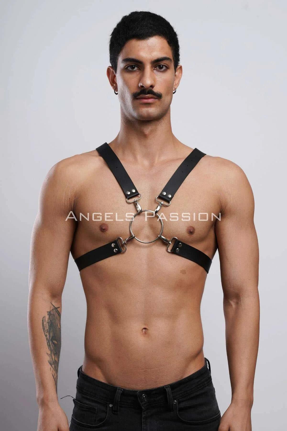 Black faux leather chest harness with silver O-ring and X-back straps worn by male model