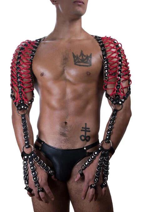 Red faux leather strips woven through black chain links forming cage-style shoulder panels with silver studs