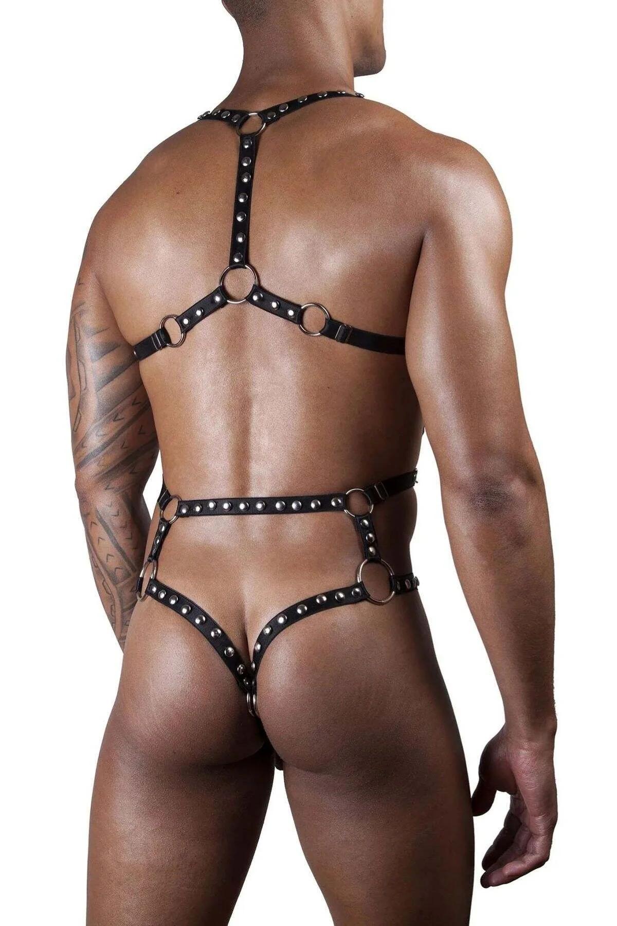 black studded body harness worn over white fitted tee showing layering contrast