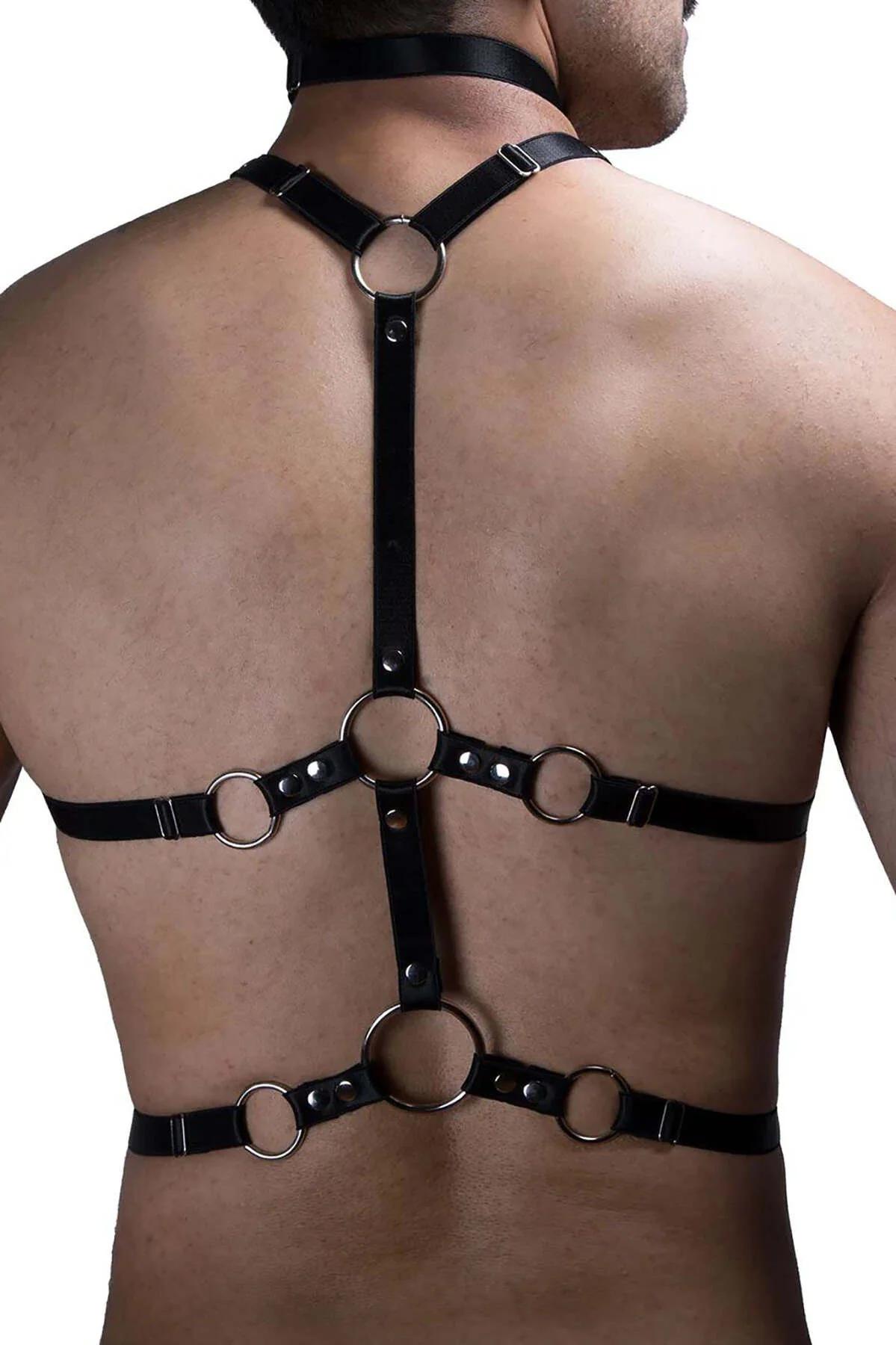 Back buckle closure and strap adjustment on black faux leather men's chest harness