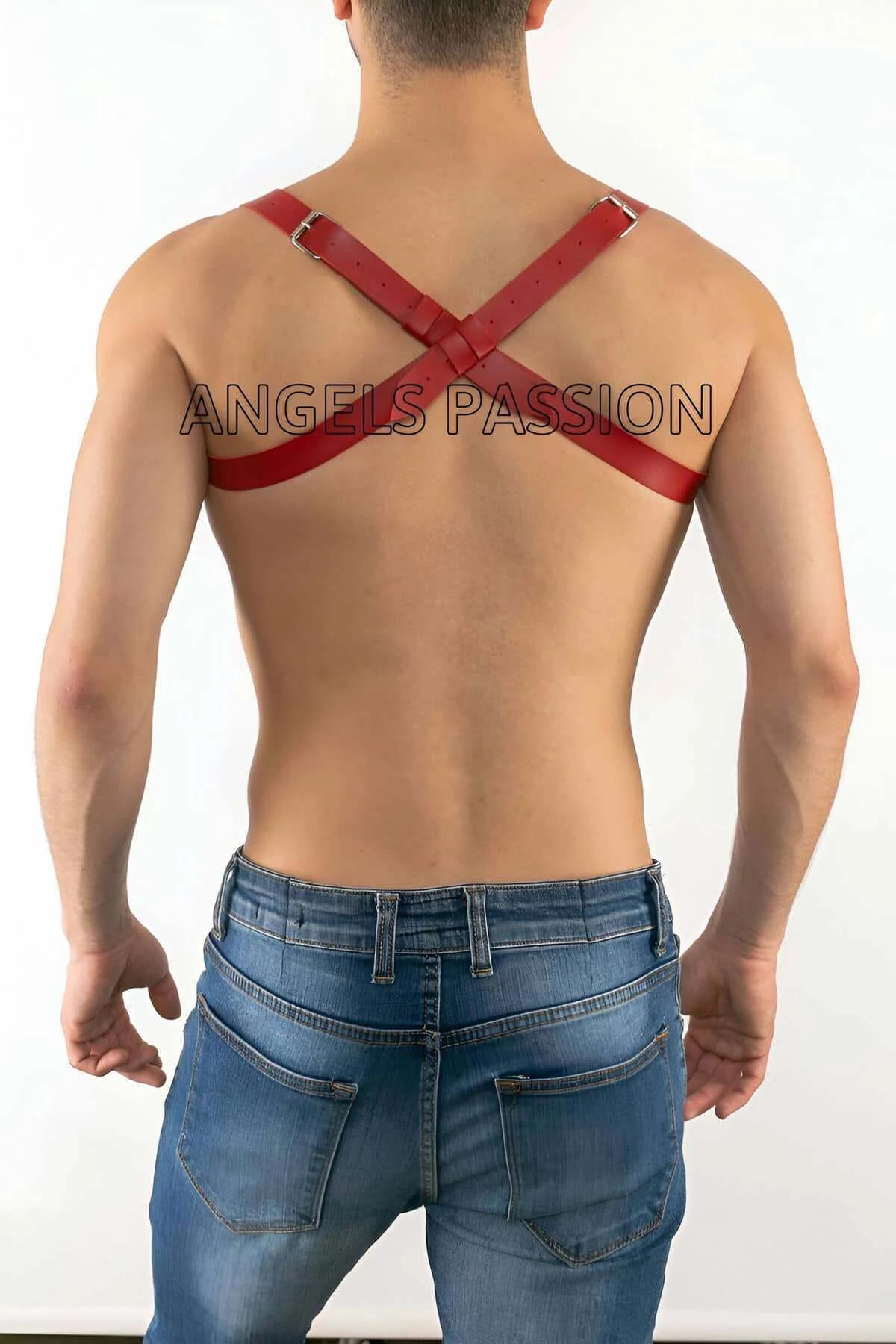 Red faux leather harness criss-cross strap detail showing silver stud rivets at junction